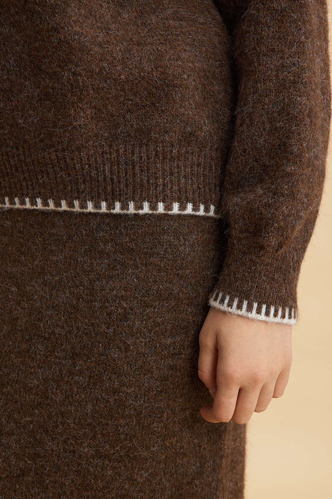 Agnes brown knit set, close-up of the cream blanket stitch at the cuff
