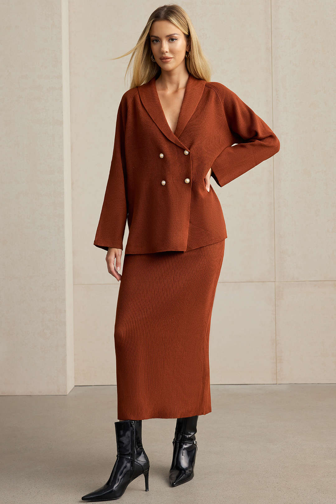 Rust knit blazer with a shawl collar worn over the matching ribbed midi skirt