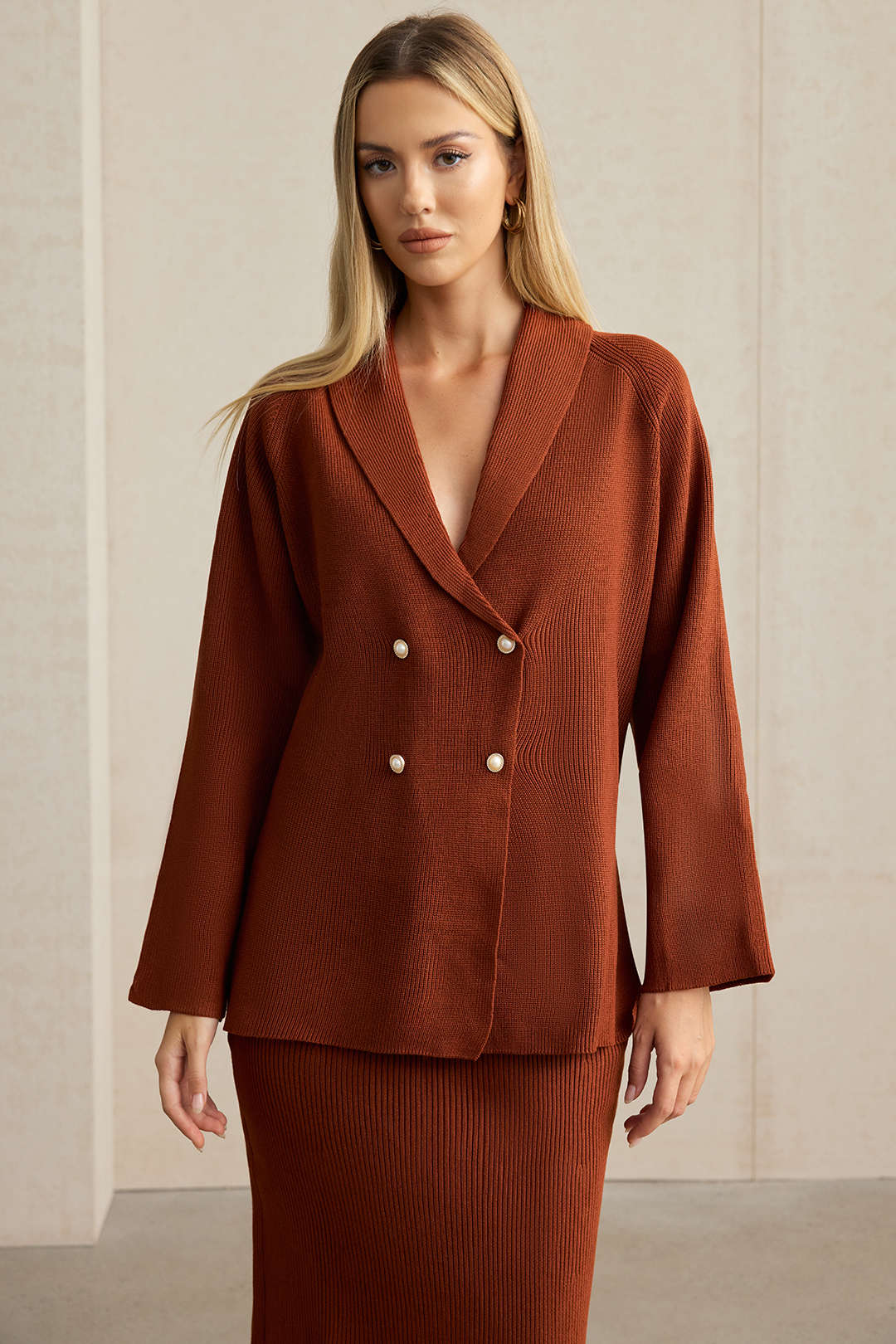 Front view of the rust double-breasted knit blazer showing the gold-tone buttons