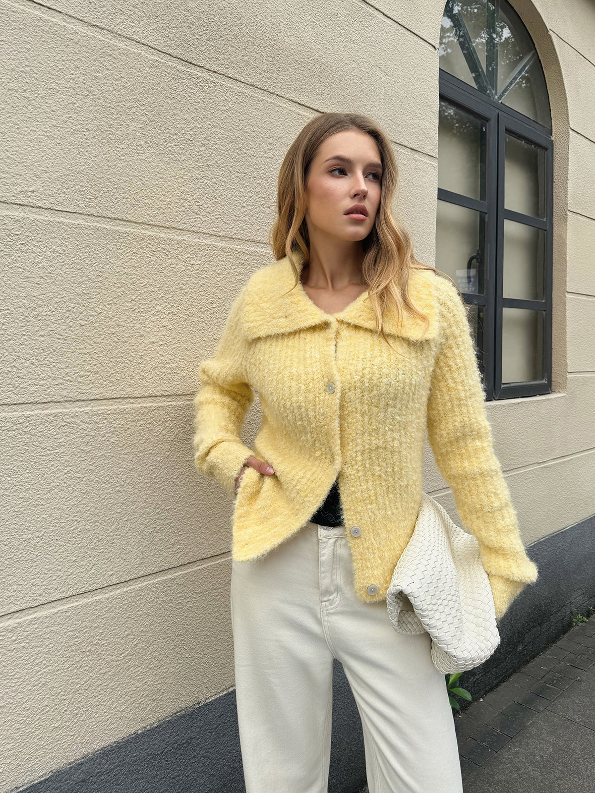 Arielle yellow button cardigan, front view worn open over a black top