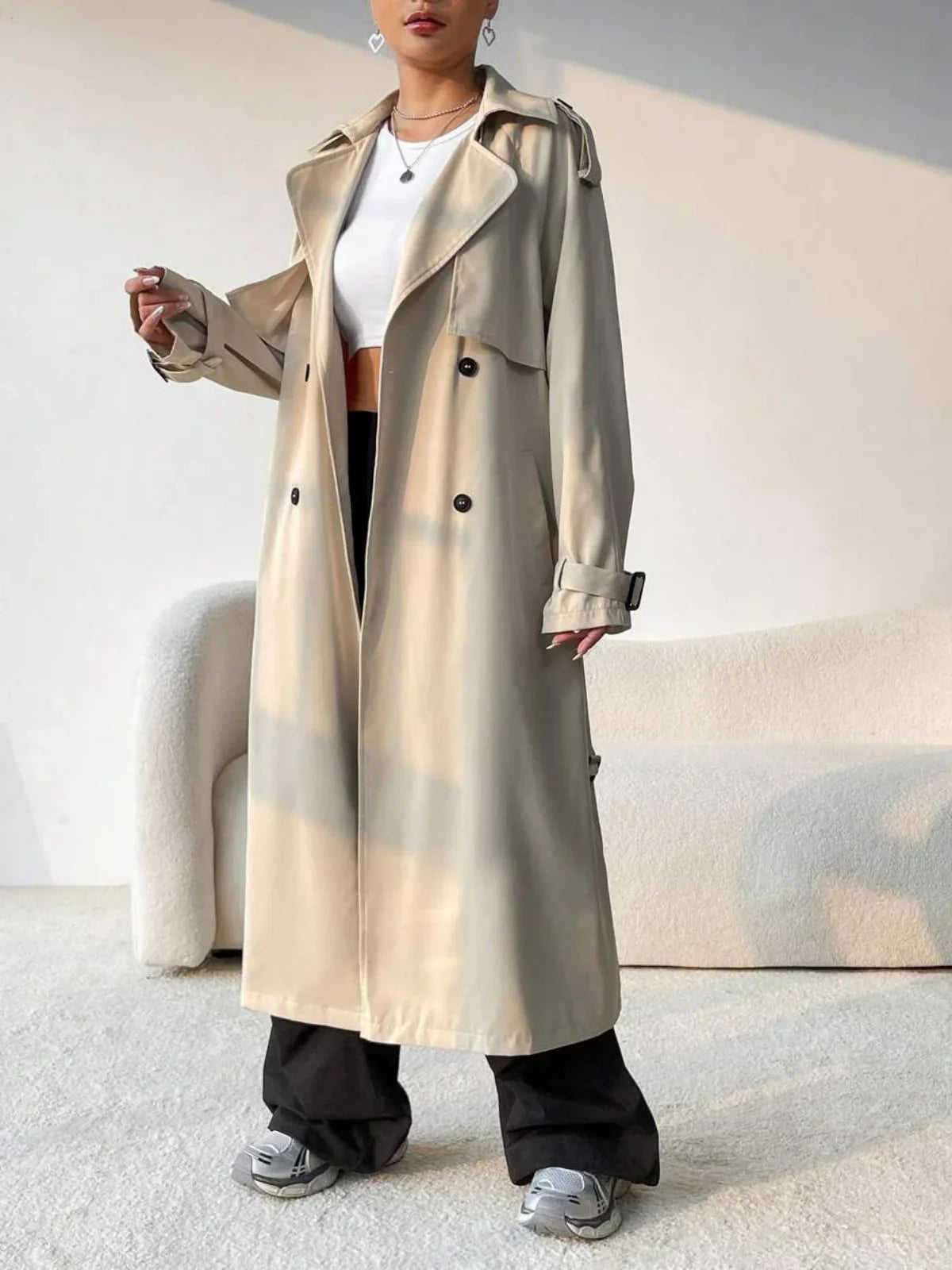 Aurore beige trench coat showing the wide lapels and shoulder epaulettes