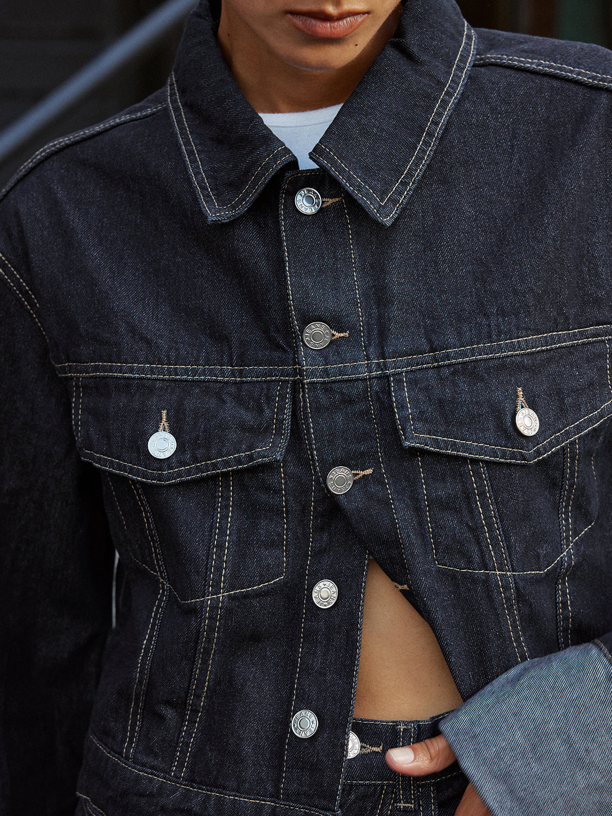 Aveline blue denim jacket close-up of the collar, button placket and chest flap pockets