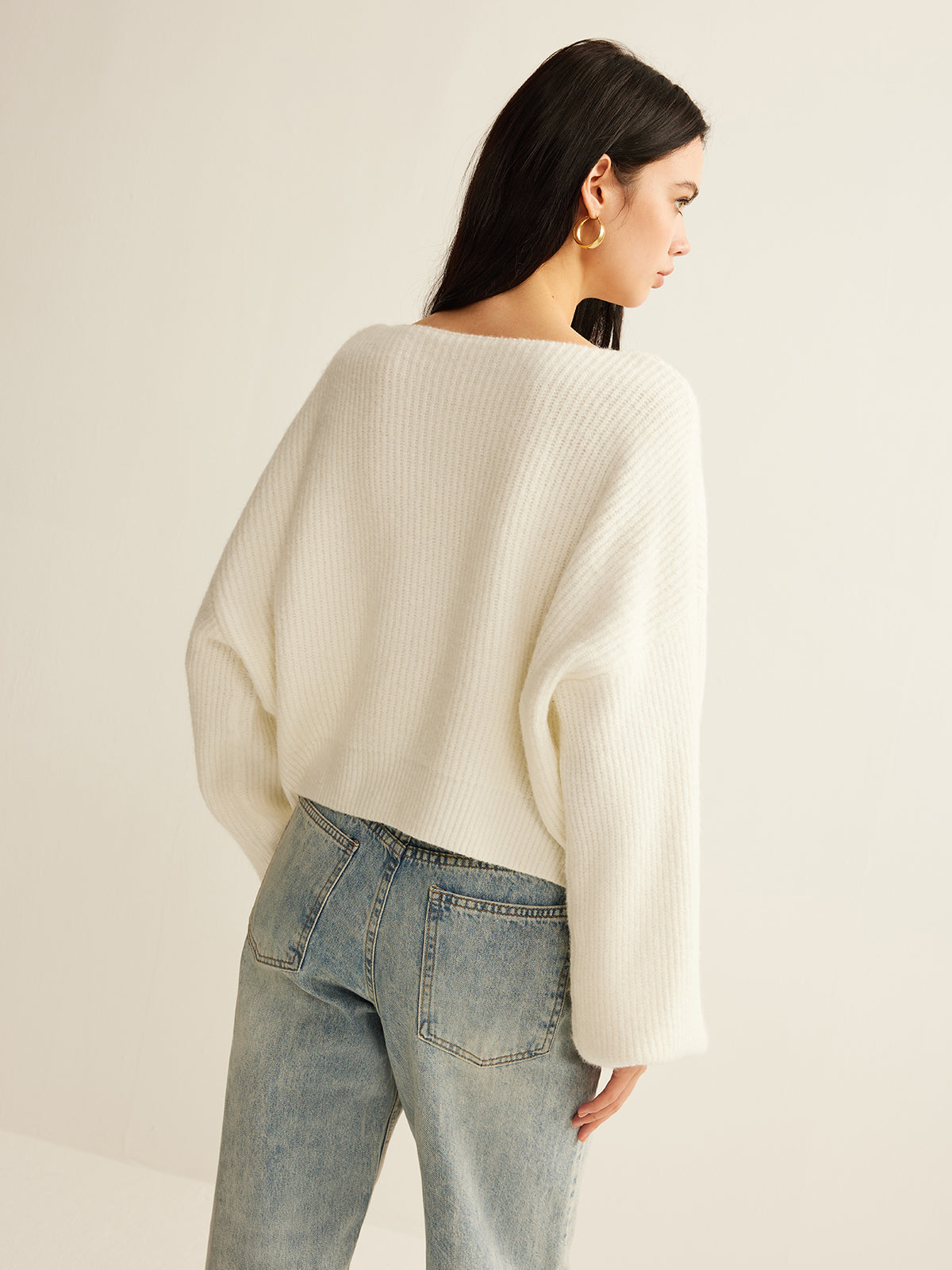 Back view of the cream cropped rib cardigan with balloon sleeves
