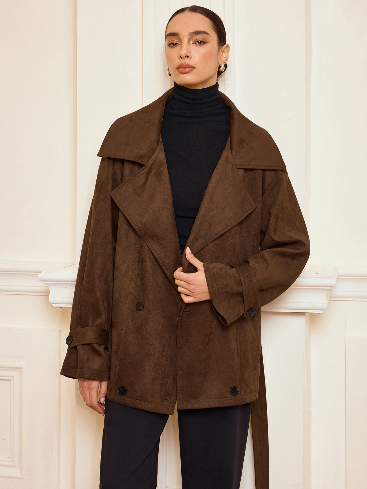 Bernadette brown coat showing the buttoned sleeve tab at the cuff