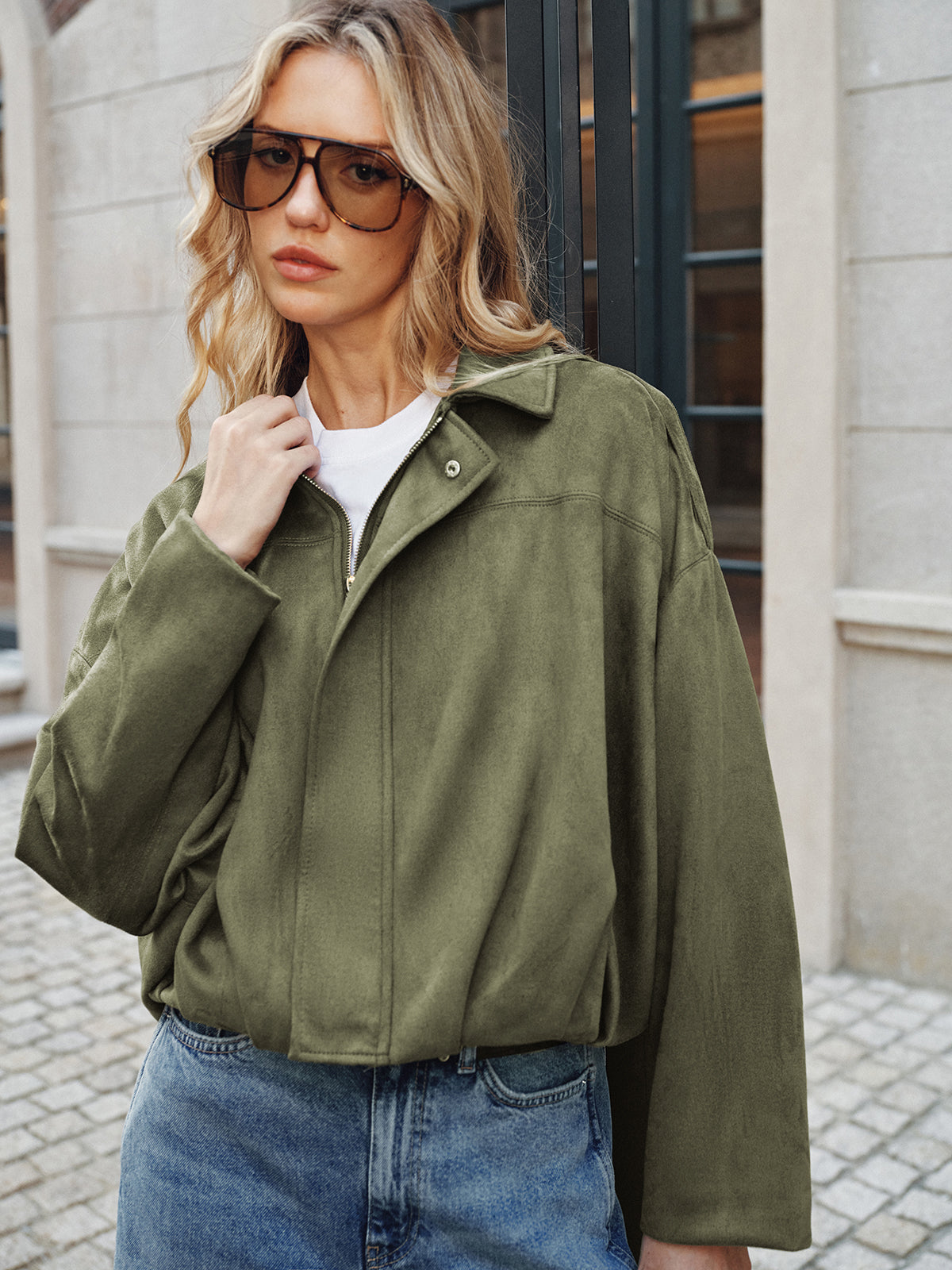 Charline green oversized wide-sleeve jacket, three-quarter view with model holding the collar
