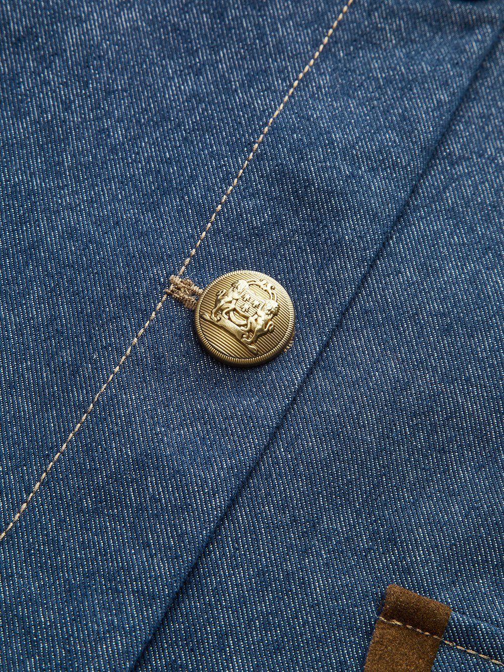 Chloe Blue denim jacket, close-up of the gold crest button
