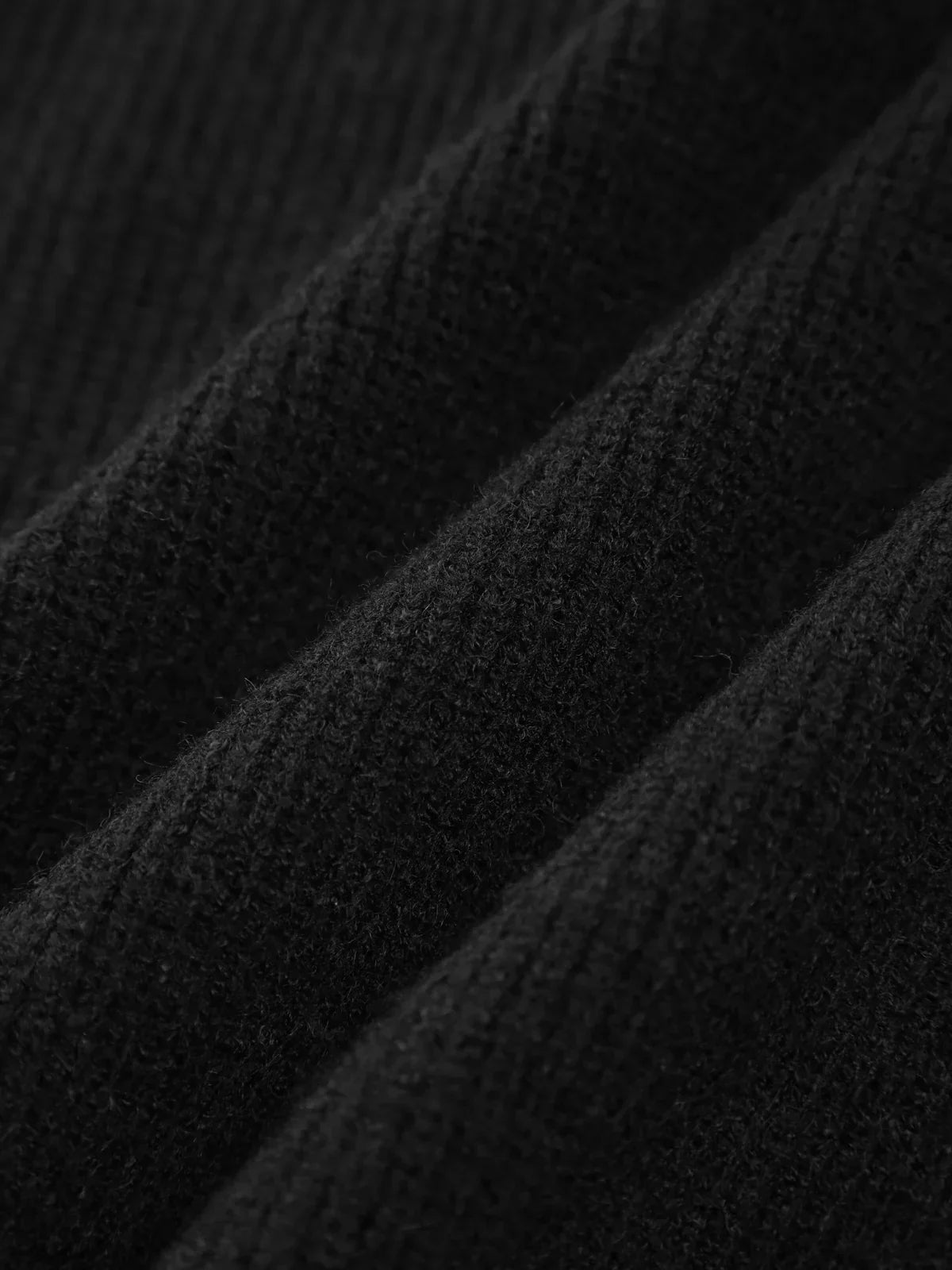 Close-up of the ribbed black knit on the Clemence sweater