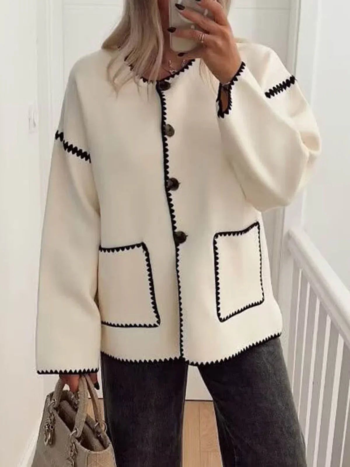 Clotilde cream collarless jacket with black contrast stitch, worn open