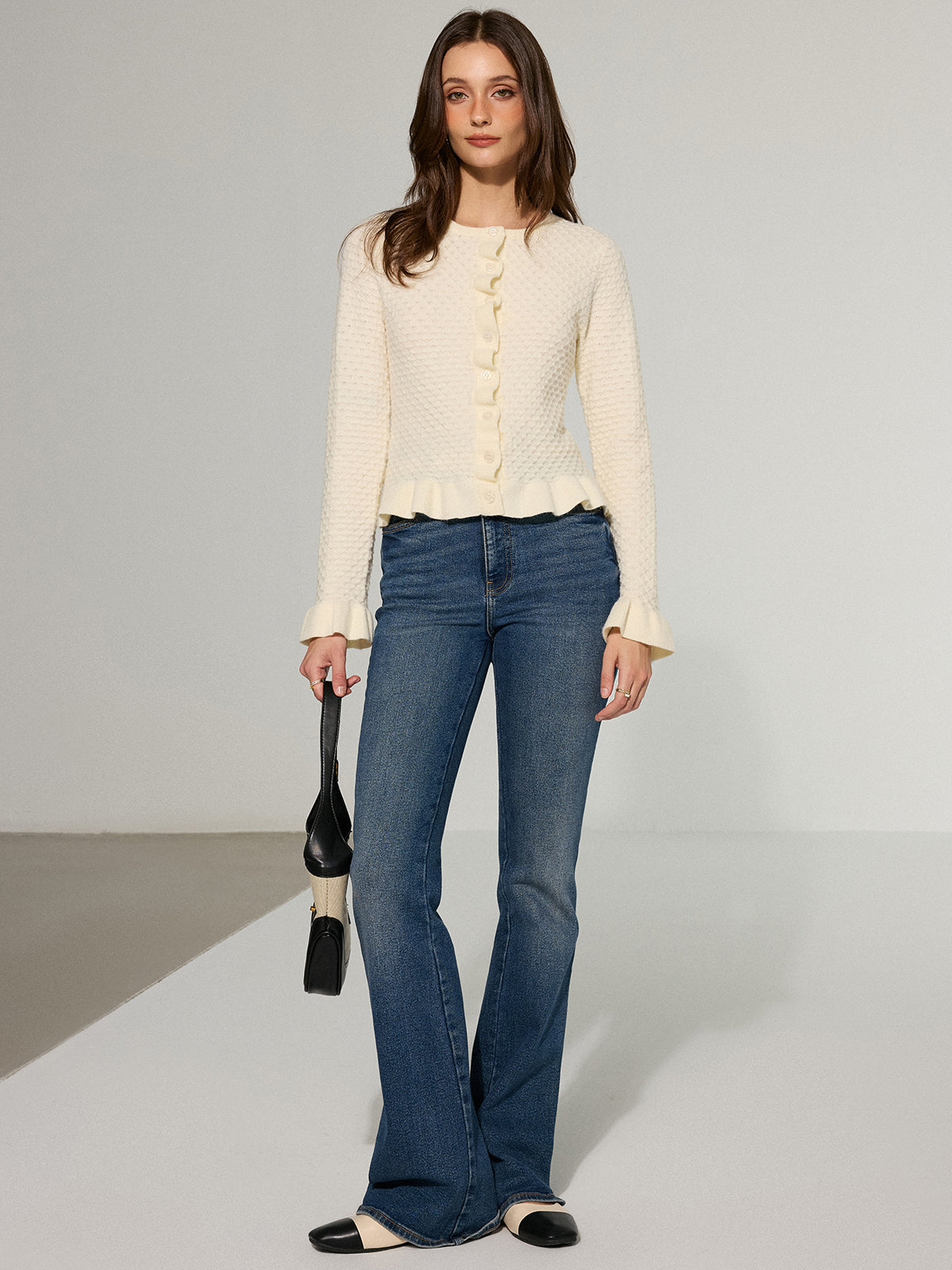 Colombe cream cropped cardigan worn with flared jeans, full-length view