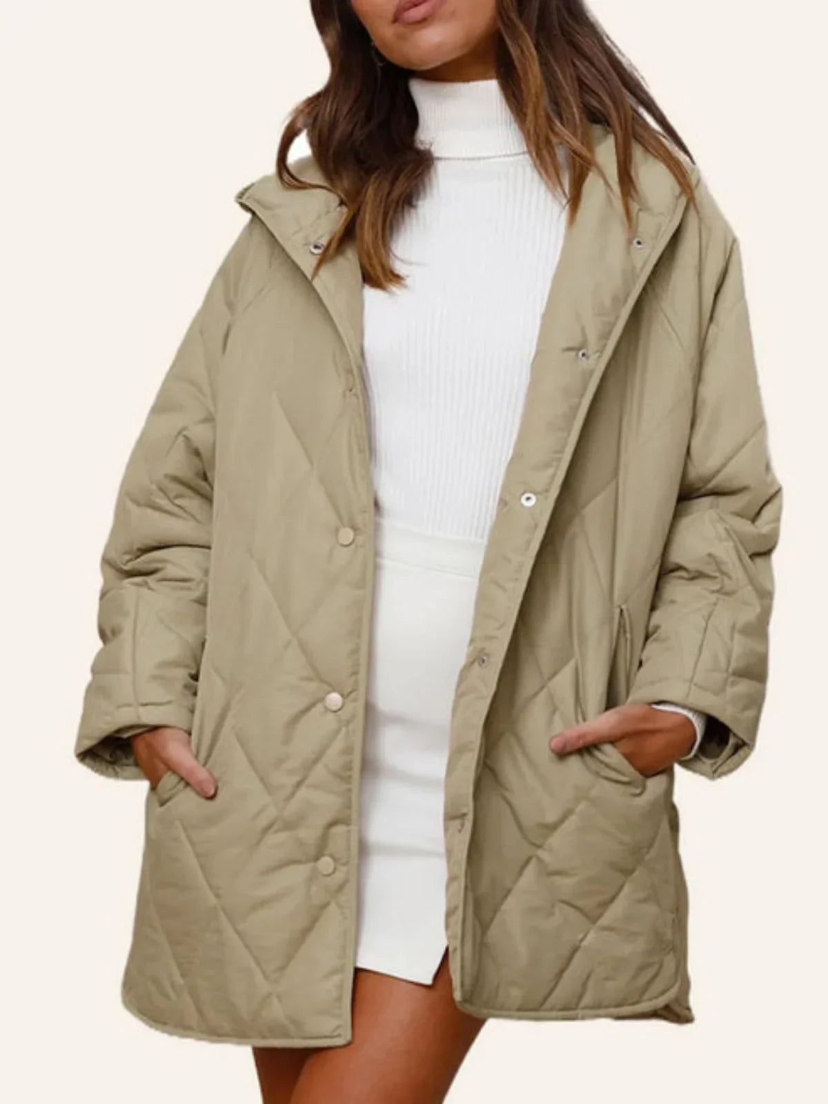 Eleonore khaki hooded quilted coat with hands in the side pockets, front view