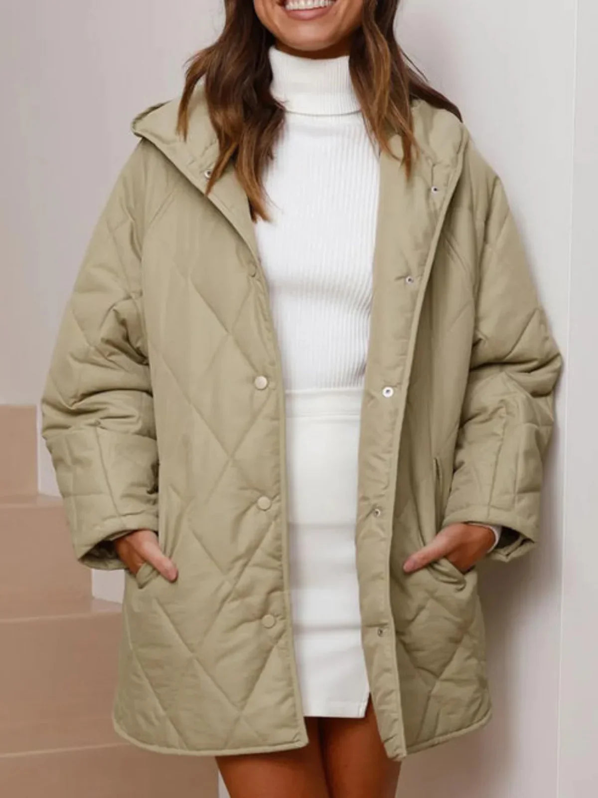Eleonore khaki quilted coat worn open over a white dress