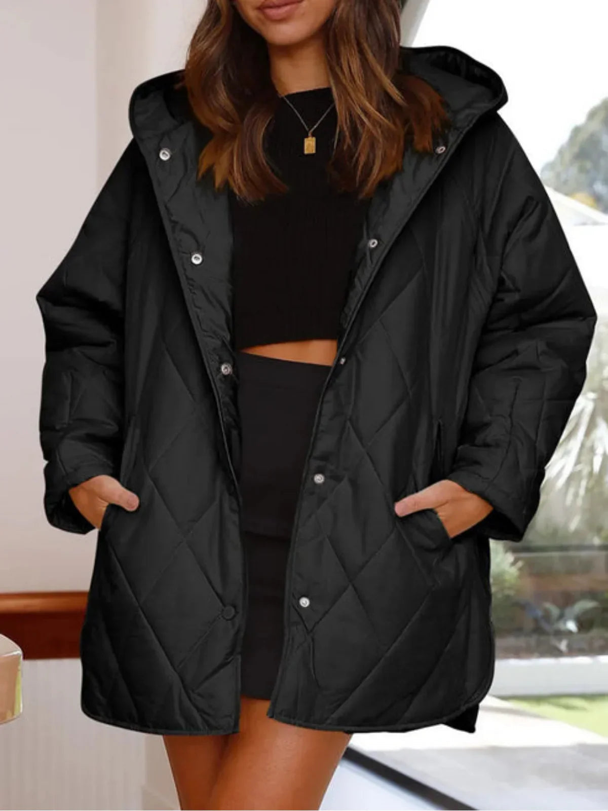 Eleonore black hooded quilted coat worn open, front view