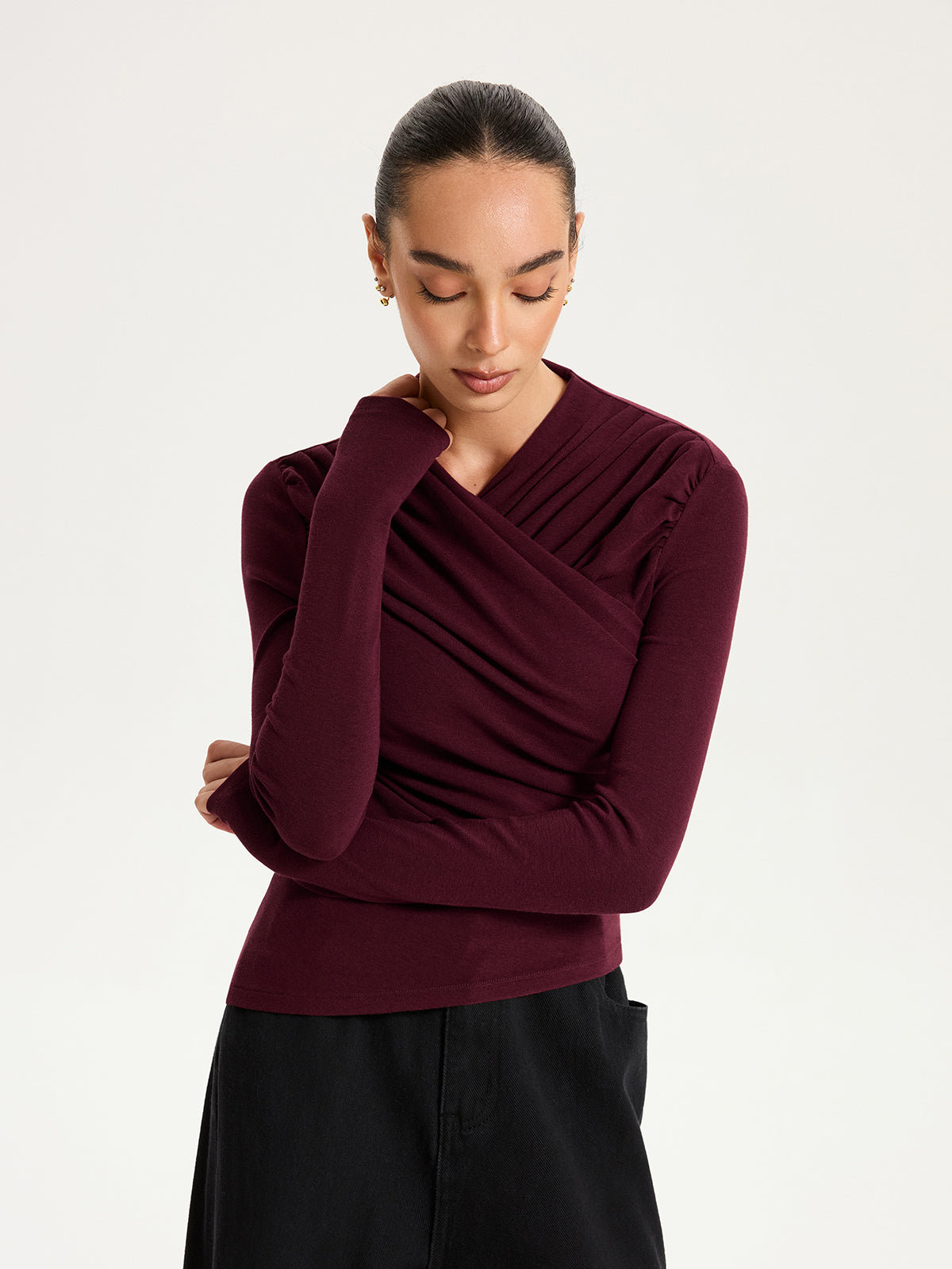 Emmanuelle burgundy draped crossover ruched knit top, front view of the neckline