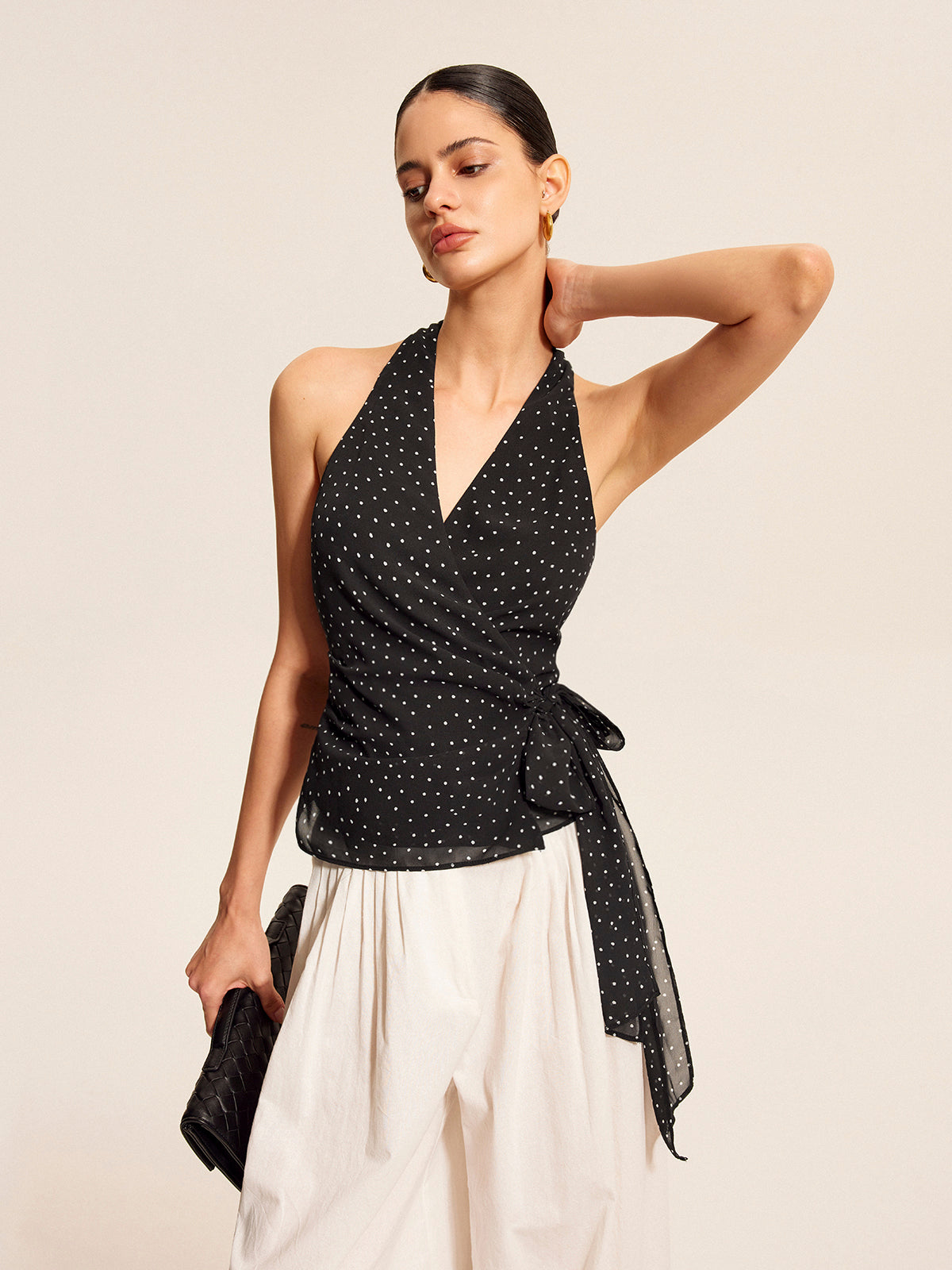 Black halter top with tie bow, side view