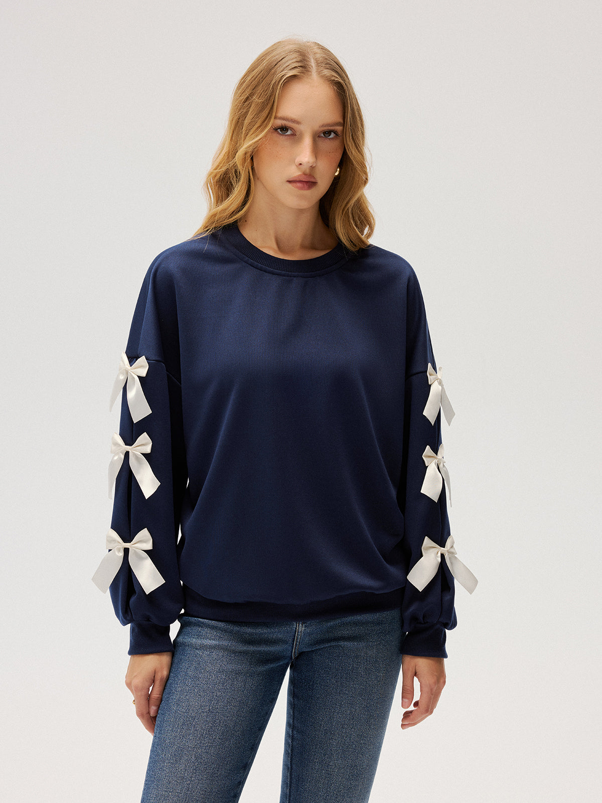 Evelyne navy ribbon bow sleeve sweatshirt, front view showing all six bows