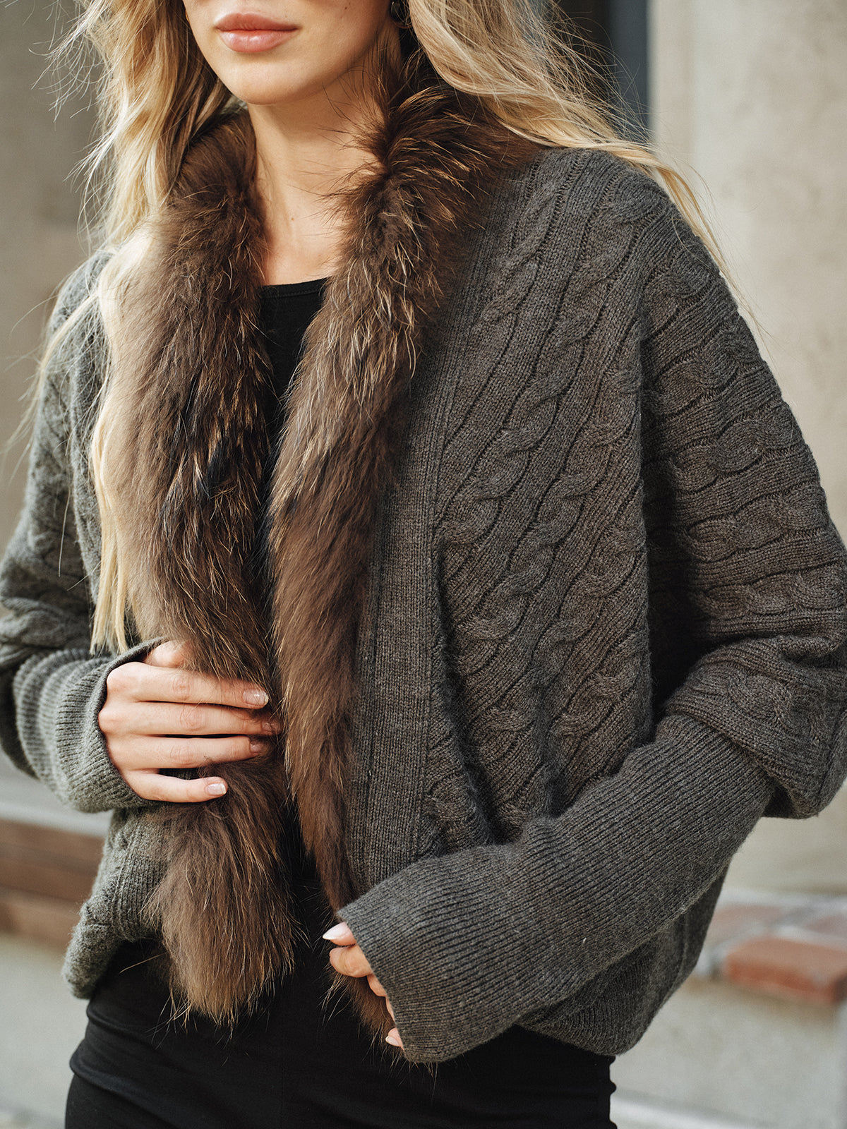 Georgette gray knit jacket close-up of the faux fur collar and cable-knit front, cropped at the waist