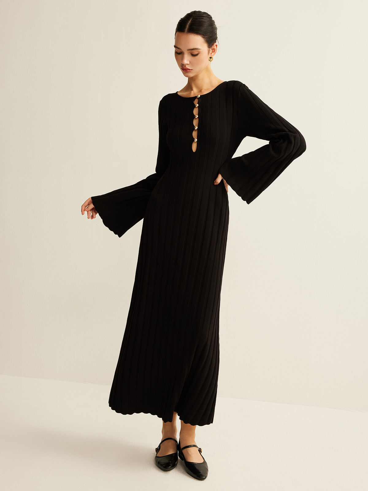 Germaine black ribbed maxi dress, side view with the bell sleeve extended