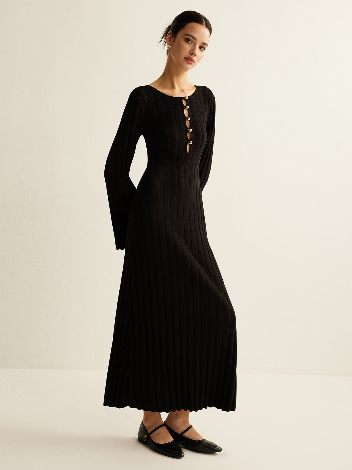 Germaine black ribbed maxi dress, three-quarter view of the fluted A-line skirt