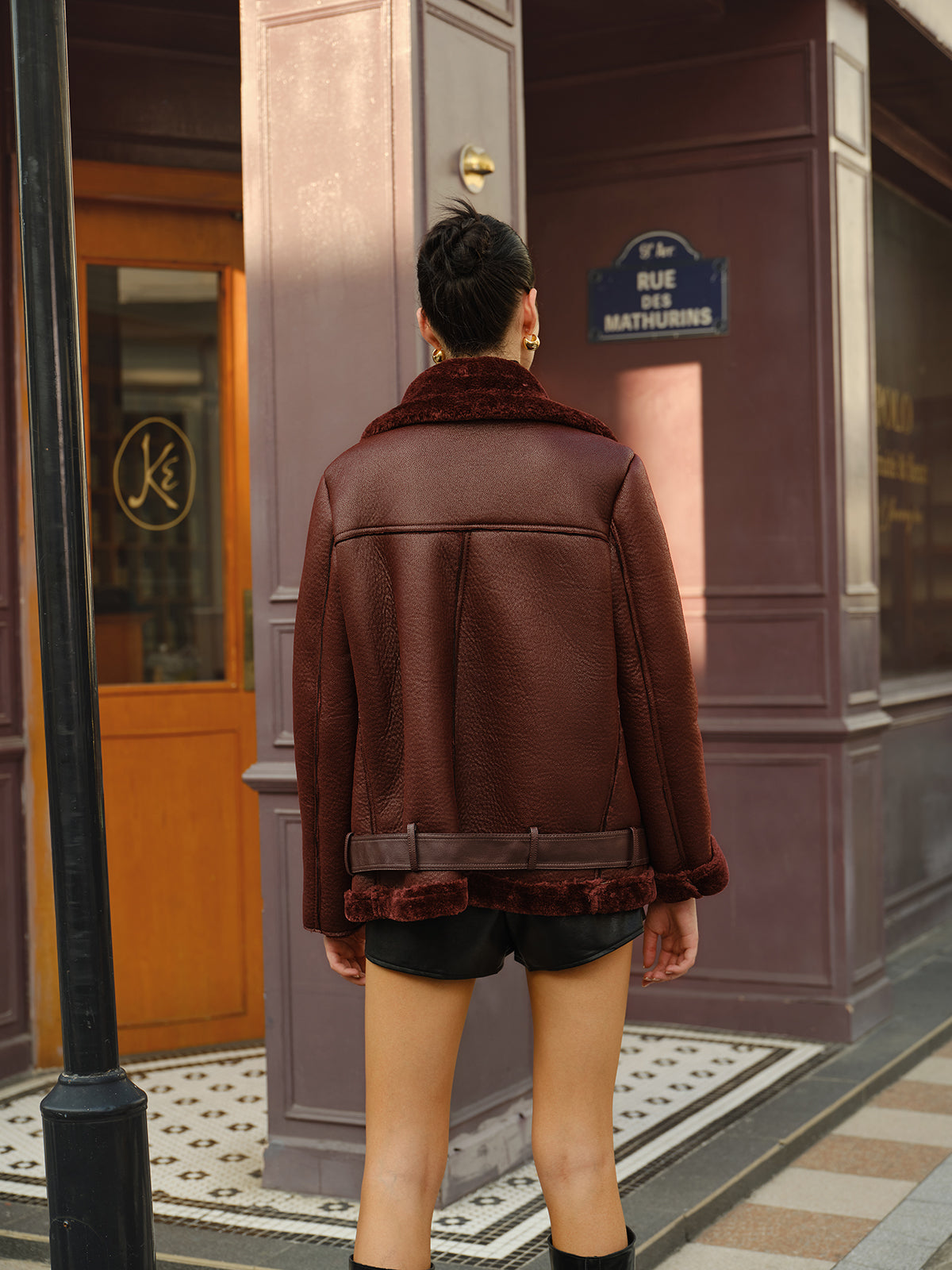 Gilberte Burgundy biker jacket, back view showing the fur-effect hem turnback