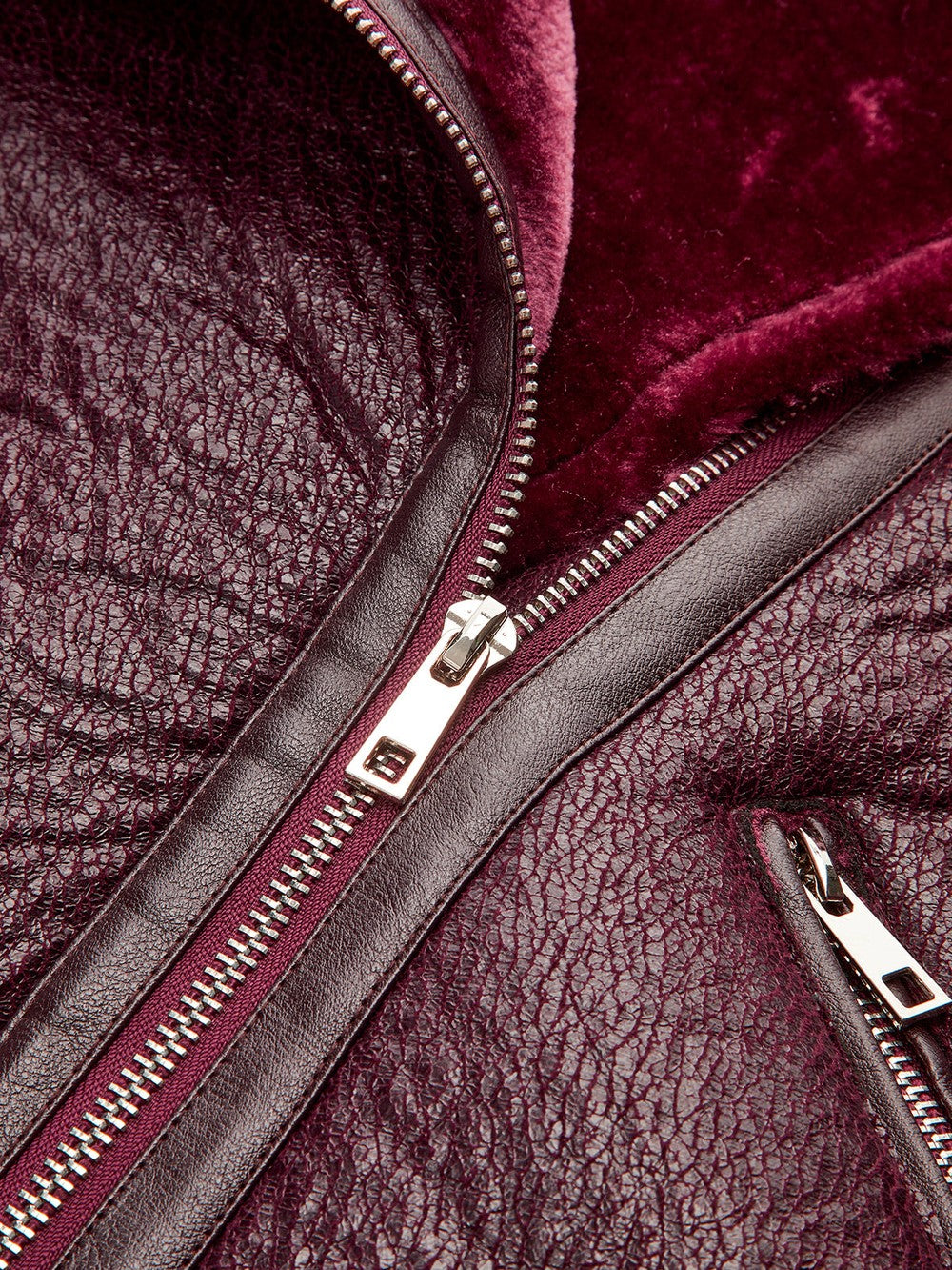 Gilberte Burgundy biker jacket, close-up of the front zip and hip pocket zip