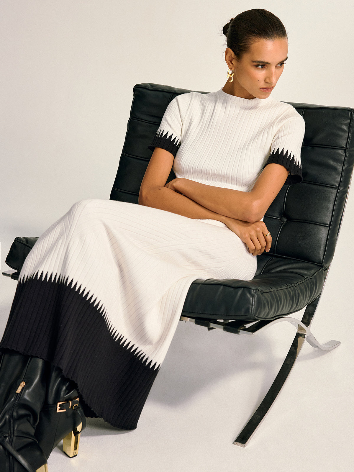 Gwenaelle white and black knit top and midi skirt set, seated side view