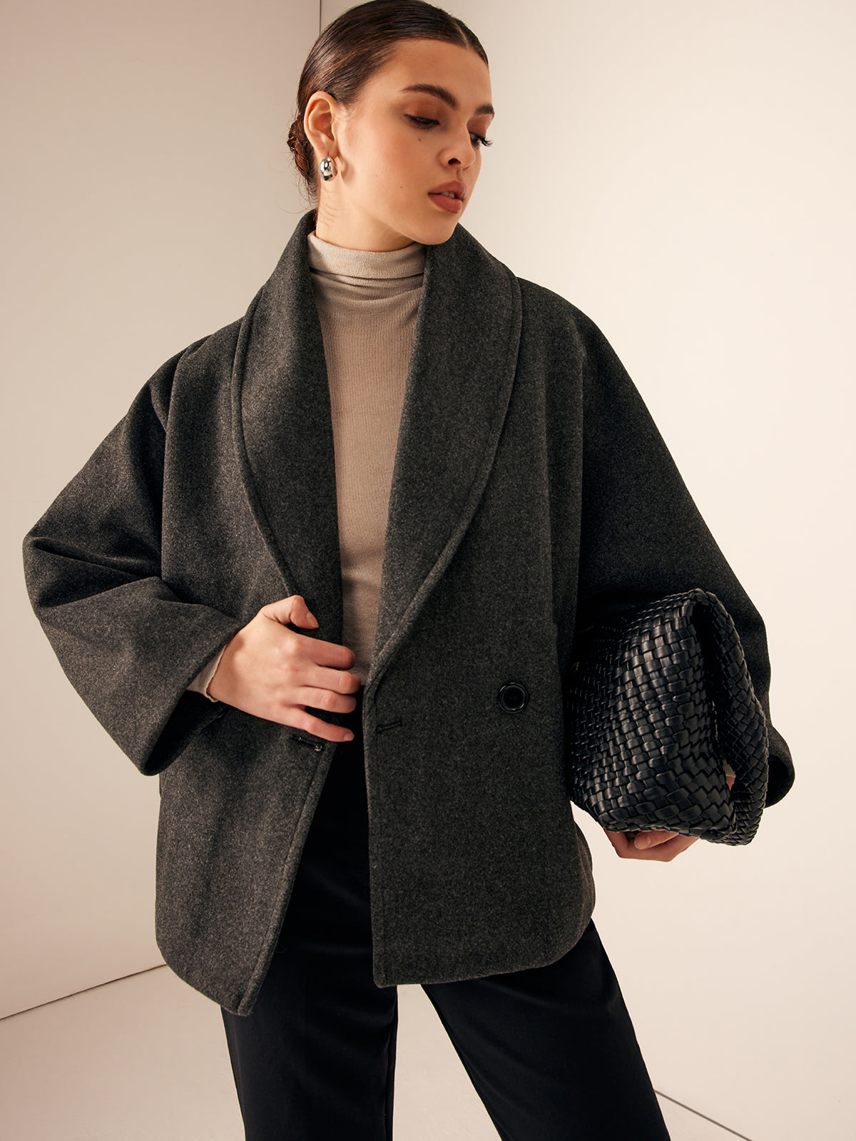 Gray oversized wide-collar jacket worn with black trousers, front view