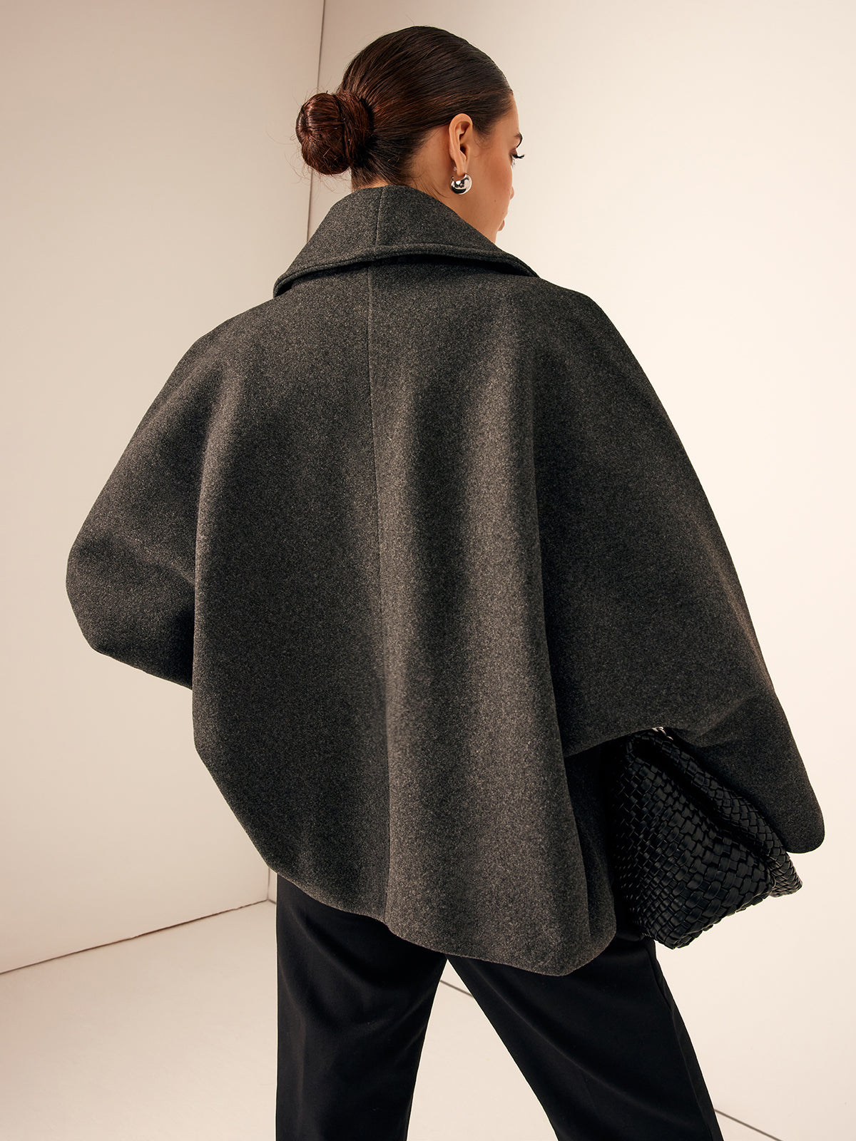 Gray oversized jacket seen from behind, showing the dropped shoulders