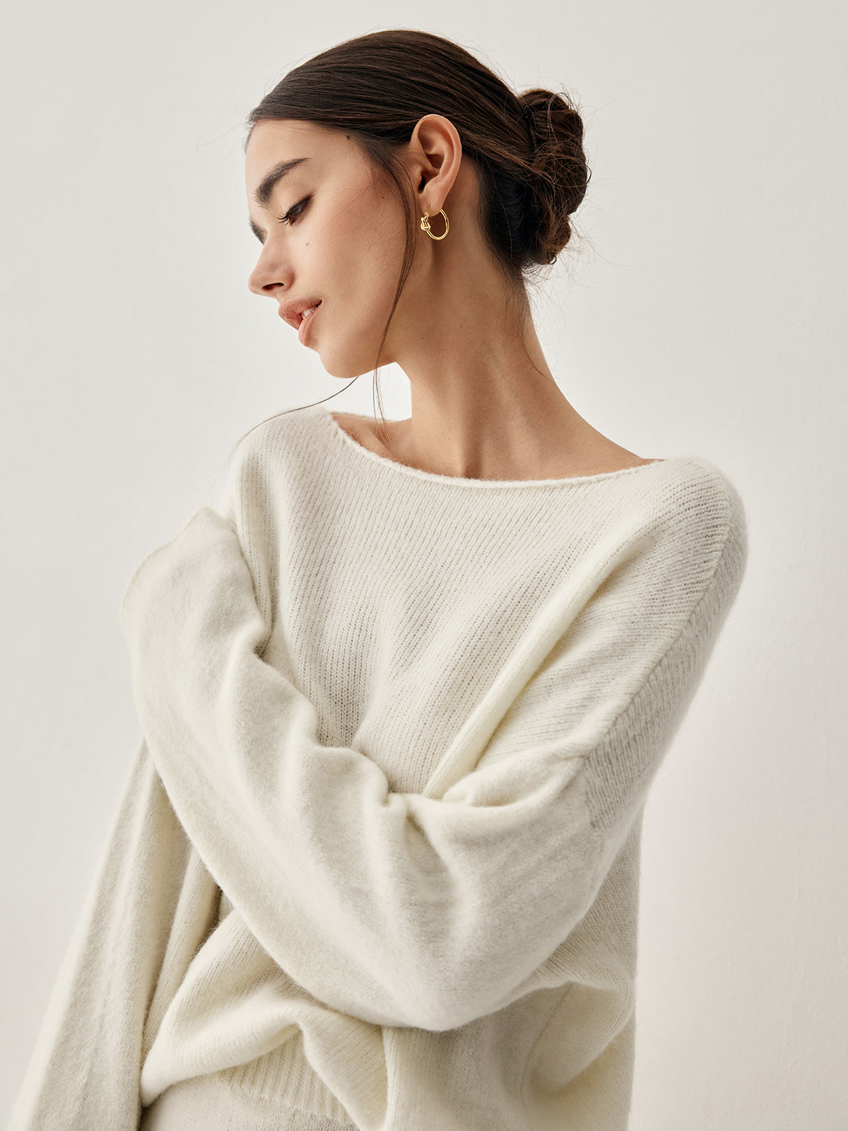 Jehanne cream sweater, close-up of the rolled raw boat neckline off the shoulder