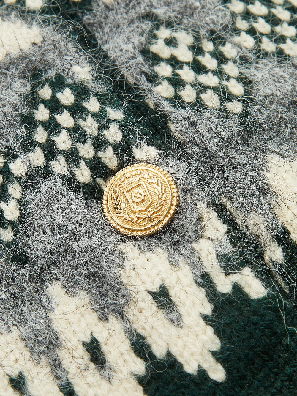 Marinette cardigan, close-up of the gold-tone button
