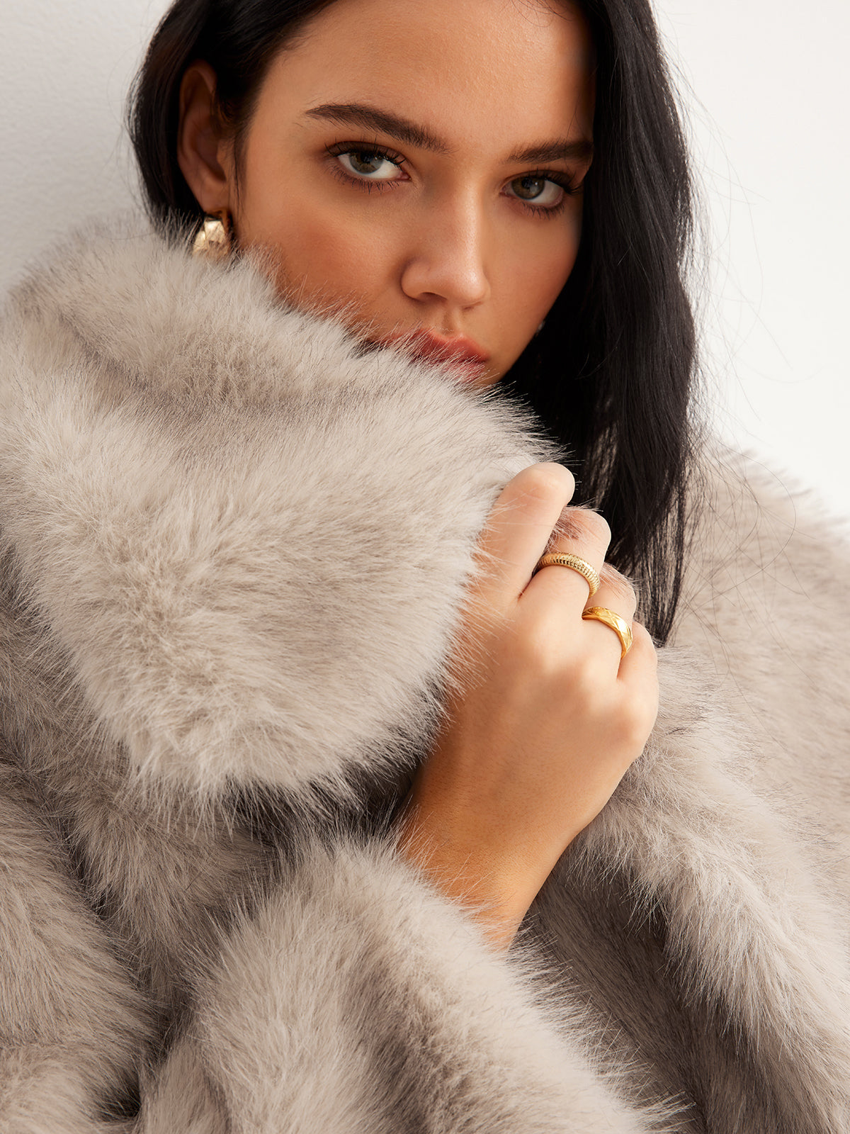 Micheline cream faux fur jacket close-up, model holding the oversized collar up against her face