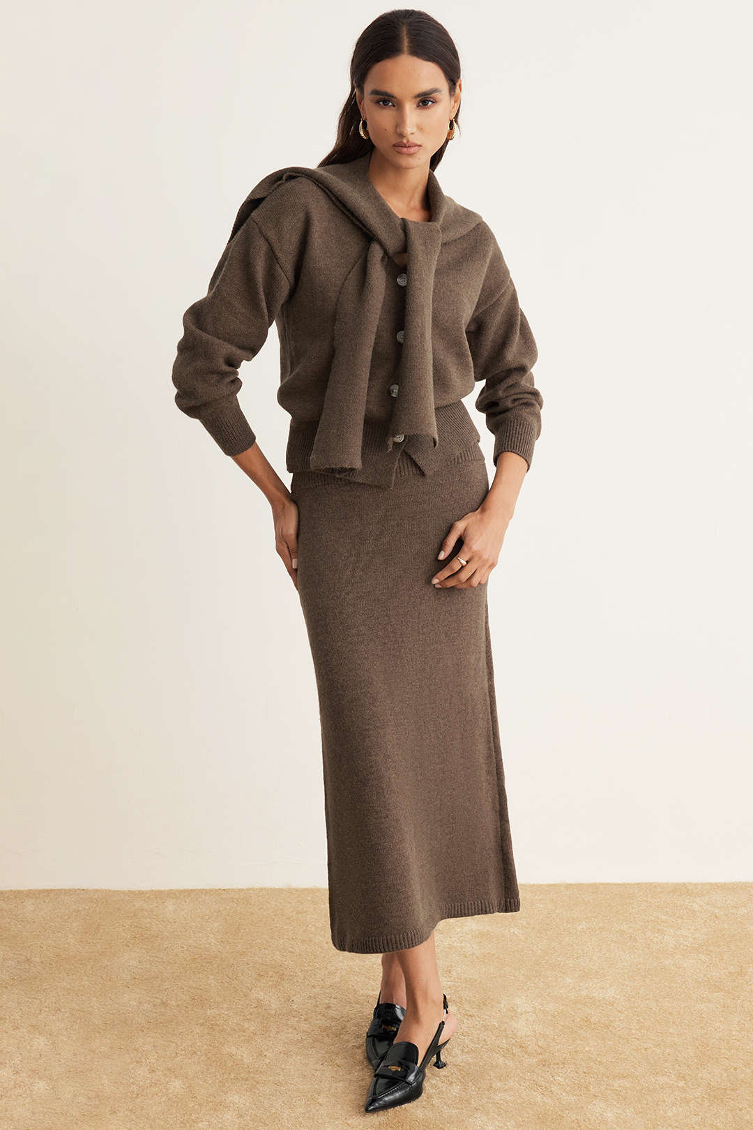 Brown knit set with the cardigan tied over the shoulders