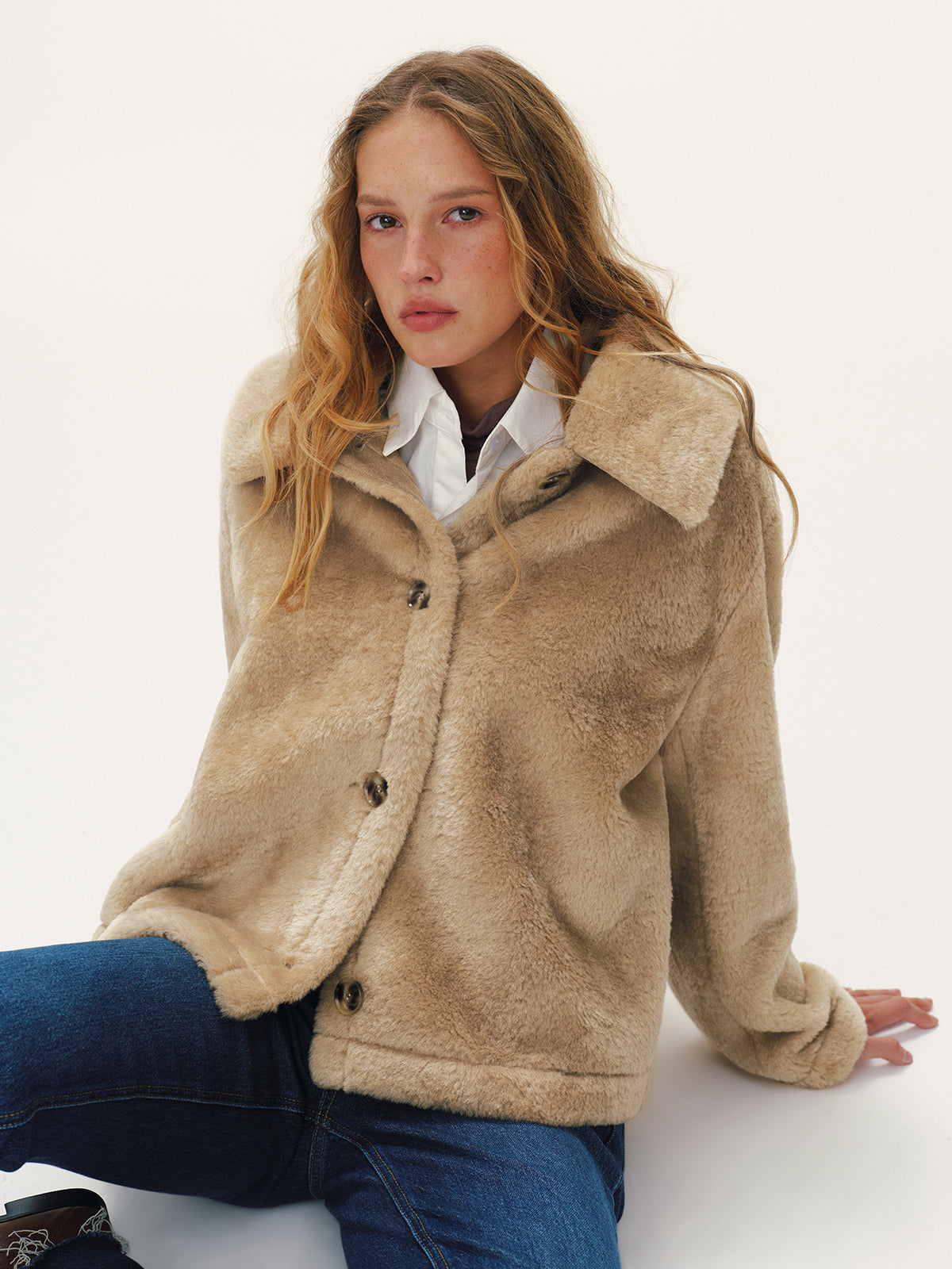 Beige plush textured jacket with the collar turned up, front view