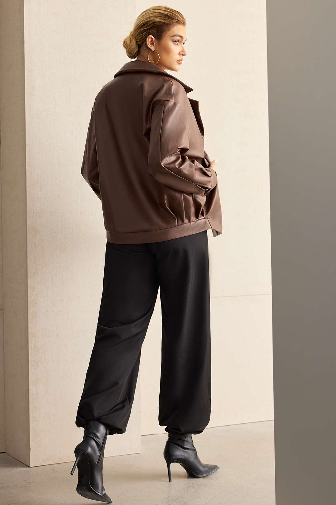 Brown double-breasted jacket seen from behind, showing the relaxed shoulder line