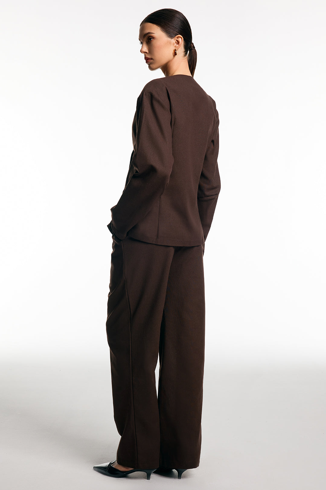 Back view of the brown cotton blazer and straight-leg trouser suit