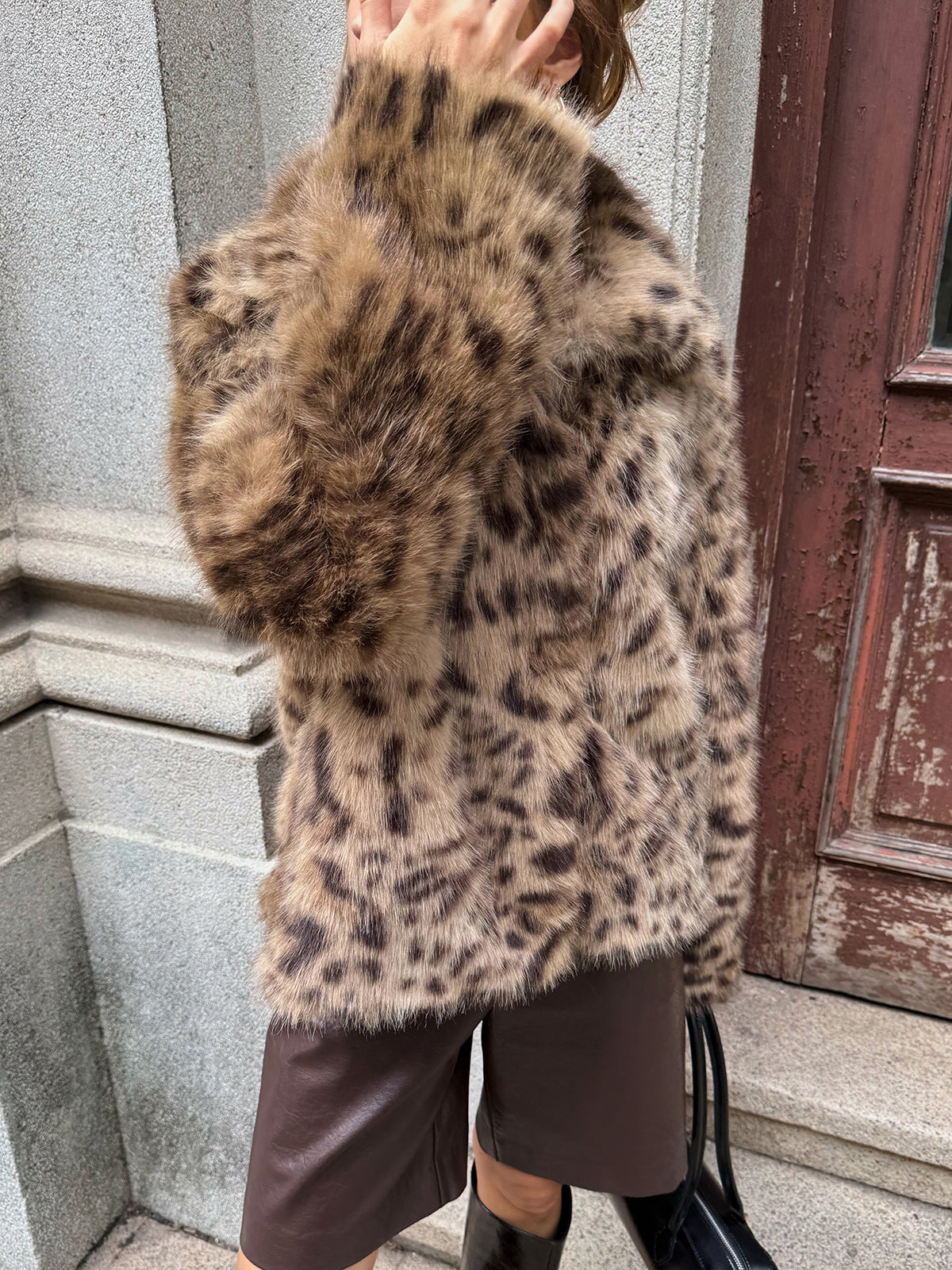 Vinciane leopard faux fur coat worn with leather shorts and boots