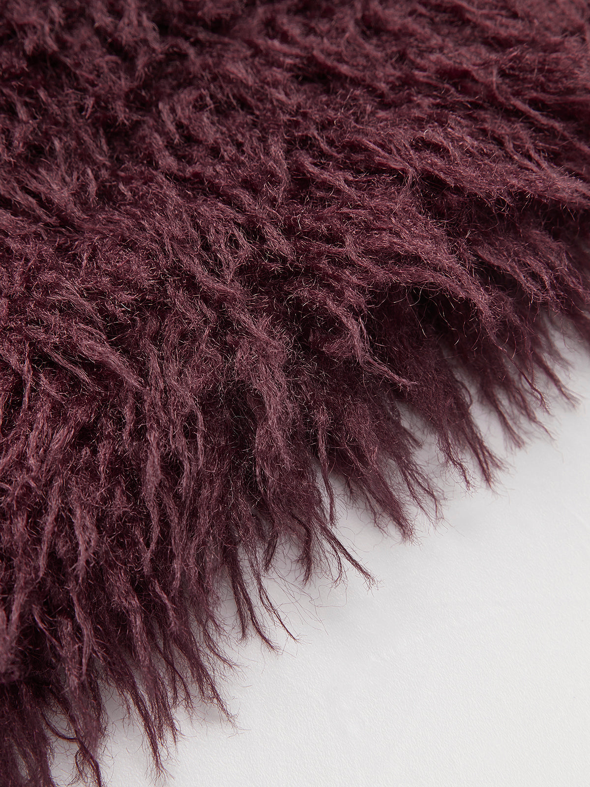 Wilhelmine Burgundy jacket, close-up of the long pile and the raw hem edge