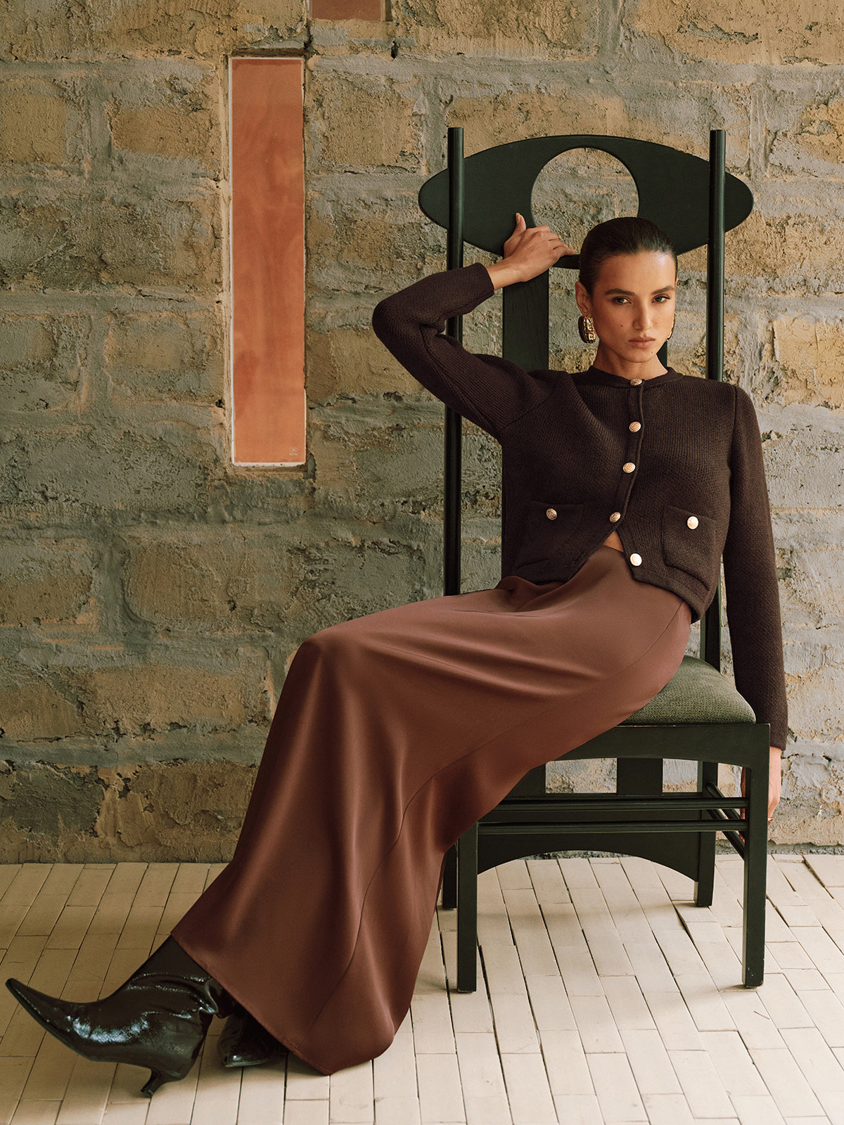 Adrienne brown gold-button cropped cardigan, full-length seated view