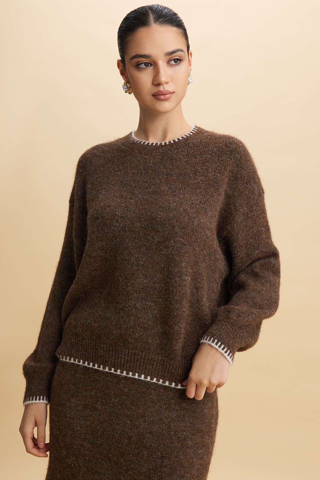 Agnes brown knit set showing the crew neckline and cream stitching