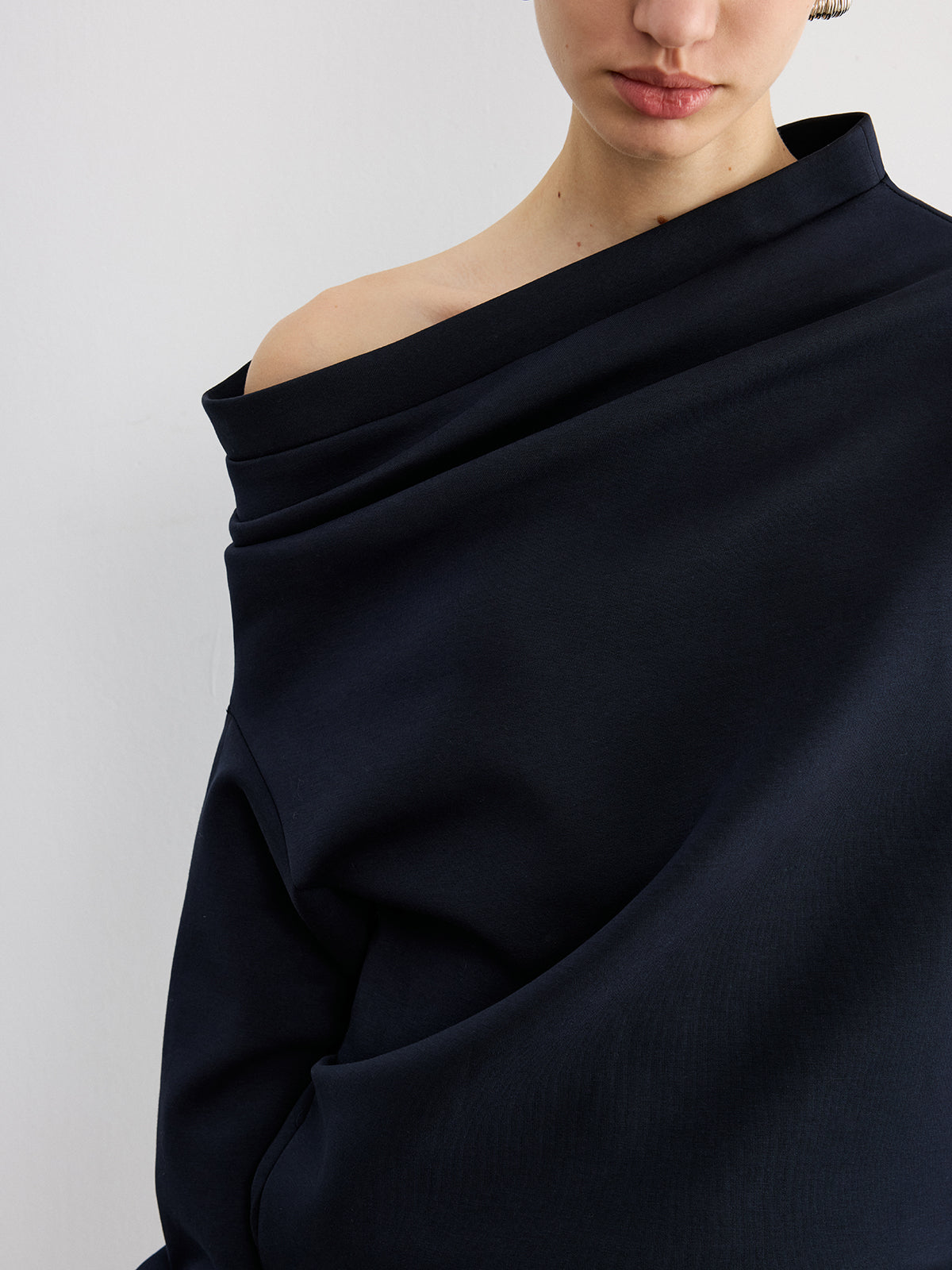 Augustine navy asymmetric off-shoulder sweatshirt, close-up of the folded neckline band