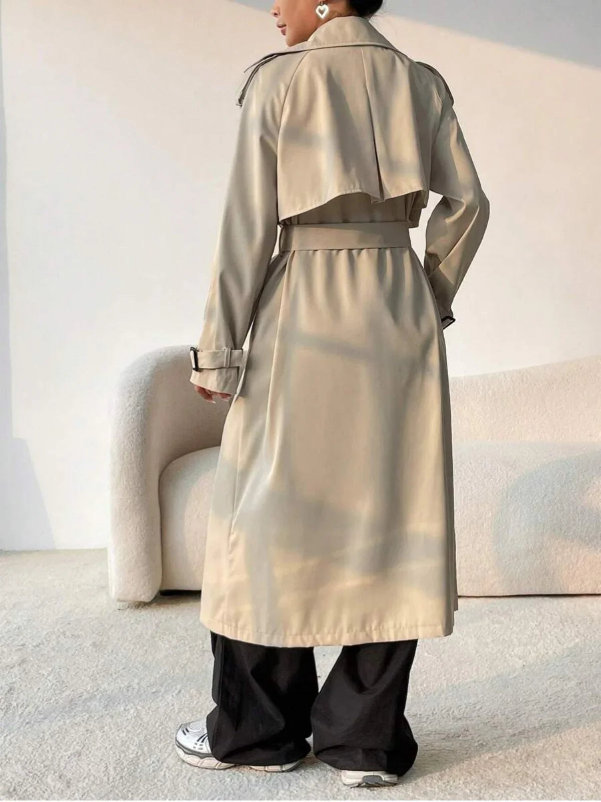 Aurore beige trench coat, back view showing the storm flap
