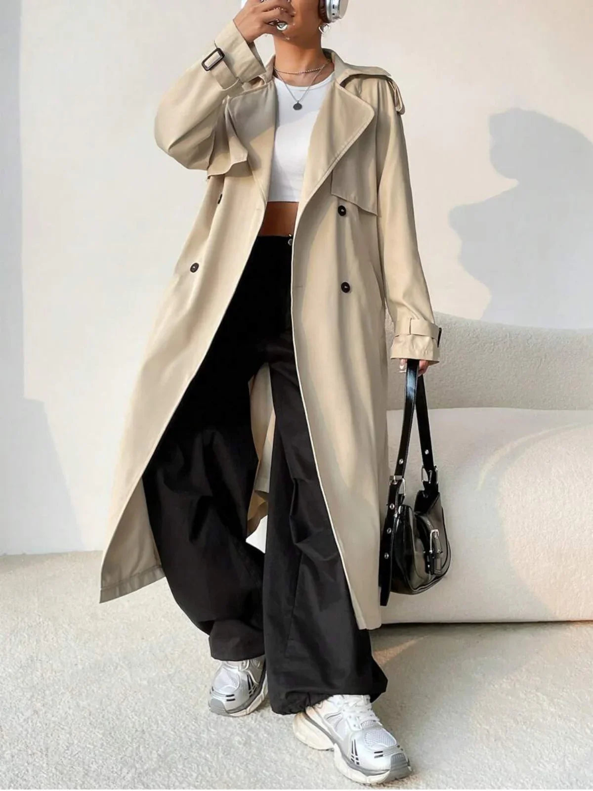 Aurore beige longline trench coat worn open with a shoulder bag