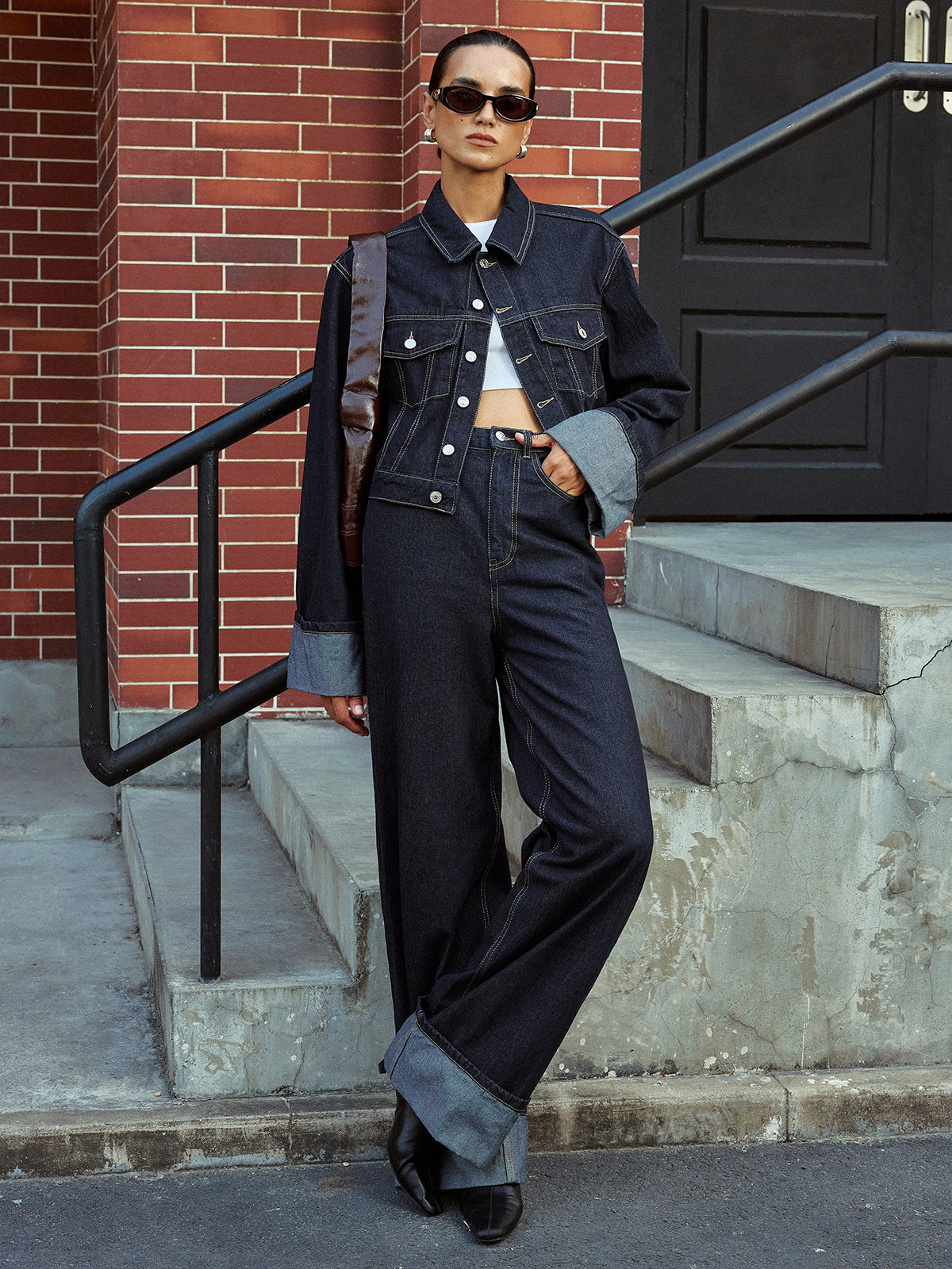 Aveline blue denim jacket worn open over wide-leg jeans, full-length standing view