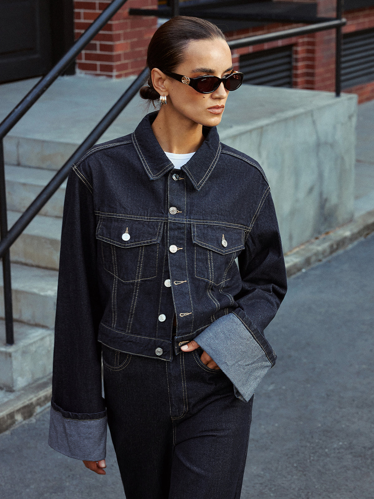 Aveline blue denim jacket buttoned, waist-up front view with both cuffs turned back