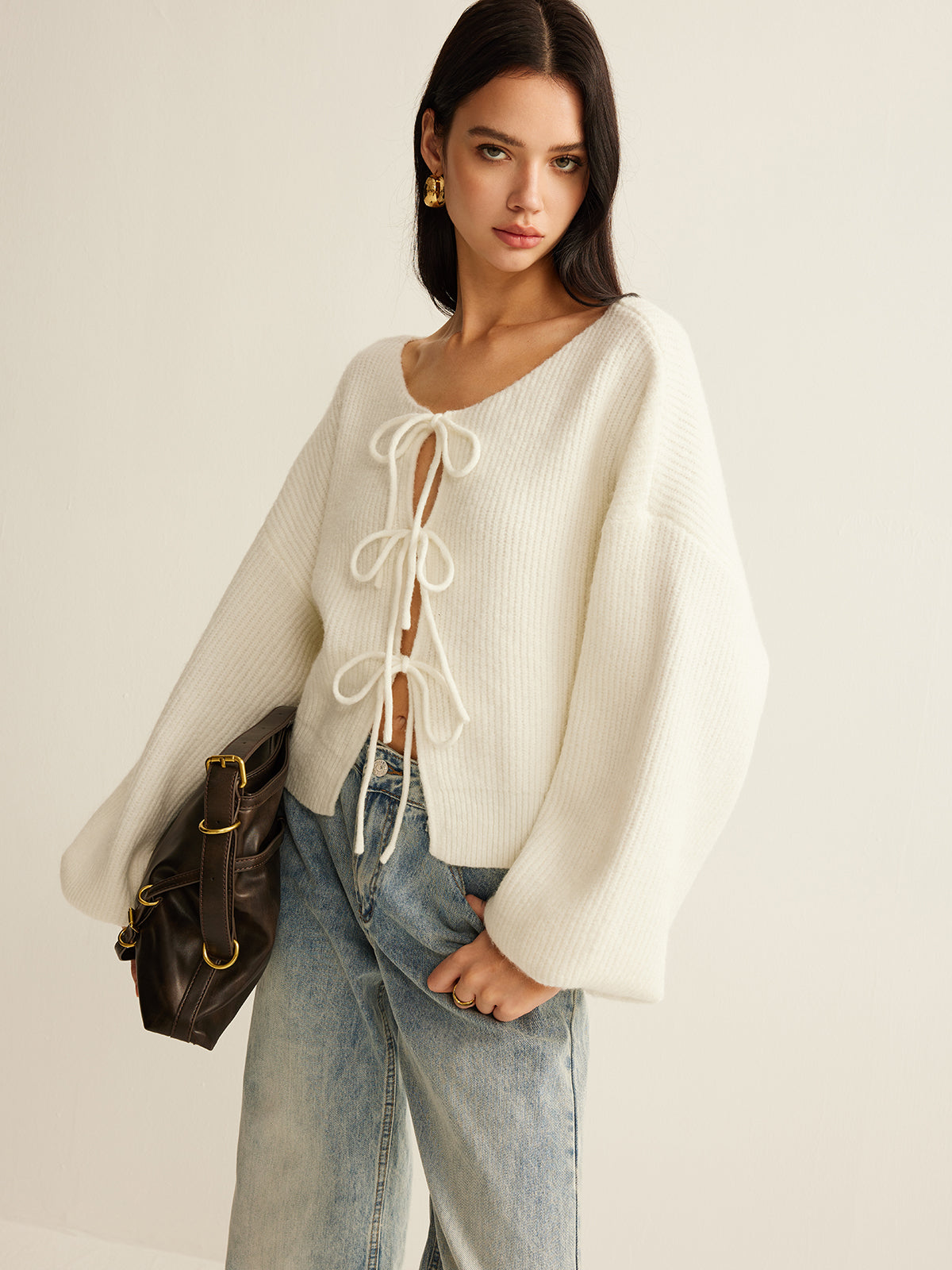 Cream cropped rib cardigan showing the three self-tie bows down the front
