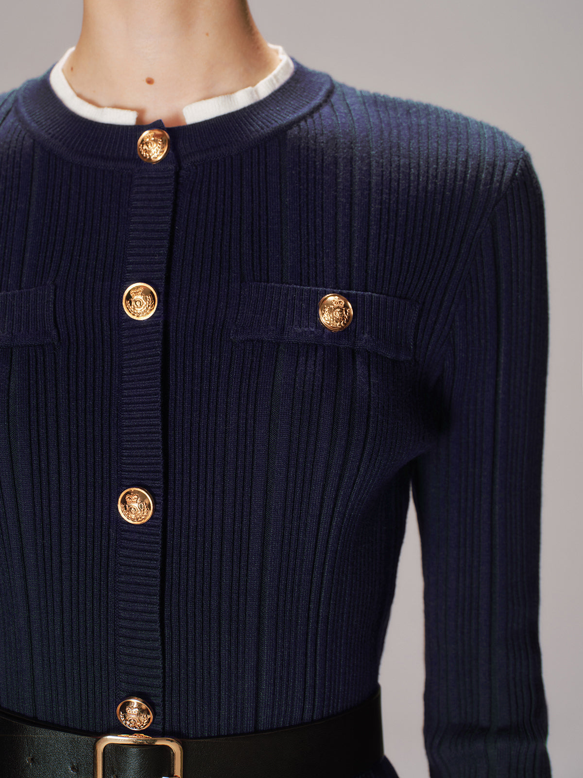 Beatrice navy ribbed knit cardigan, close-up of the gold crest buttons and pocket flaps