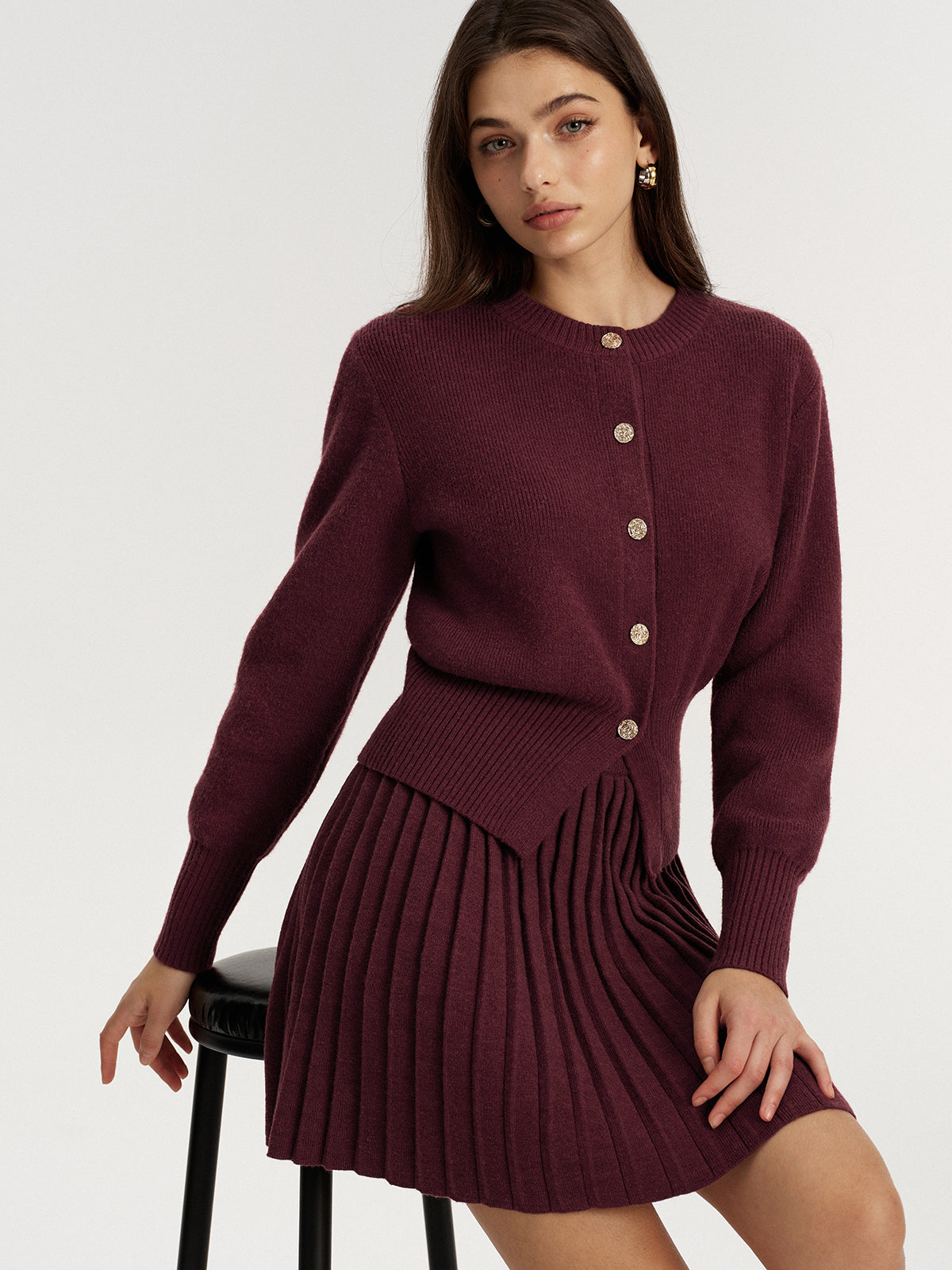 Burgundy knit set showing the pleated mini skirt and ribbed waistband