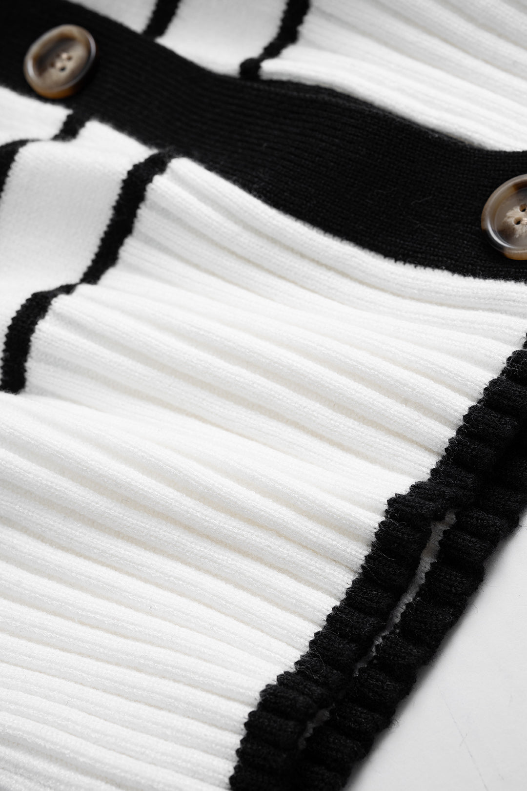 Denise Breton stripe cardigan, close-up of the white ribbed waistband and buttons