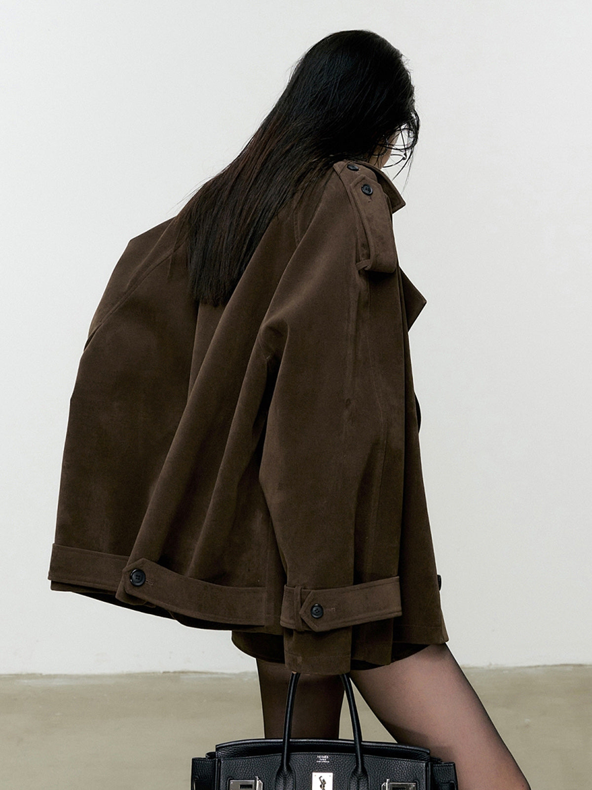 Domitille chocolate oversized trench jacket and mini skirt set, side view of the shoulder flap and cuff strap