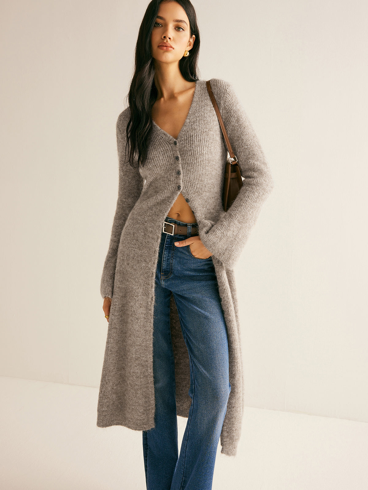 Eglantine taupe ribbed cardigan with a leather shoulder bag, angled view