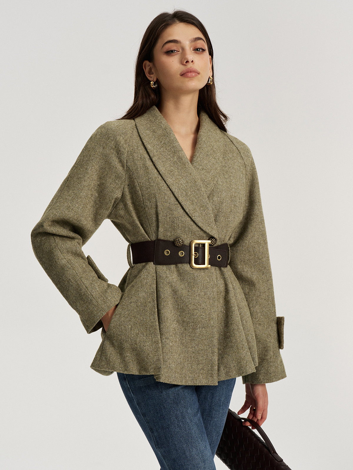 Emilienne green belted wool-blend jacket, three-quarter view with hand on hip showing flared hem